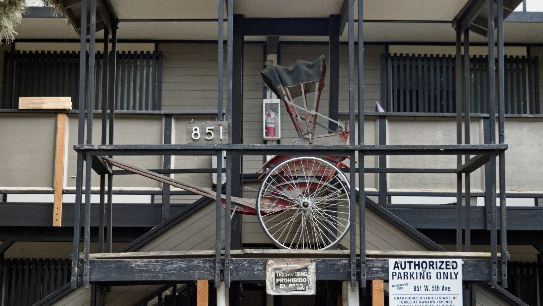 old buggy displayed on the 2nd floor of an apartment building