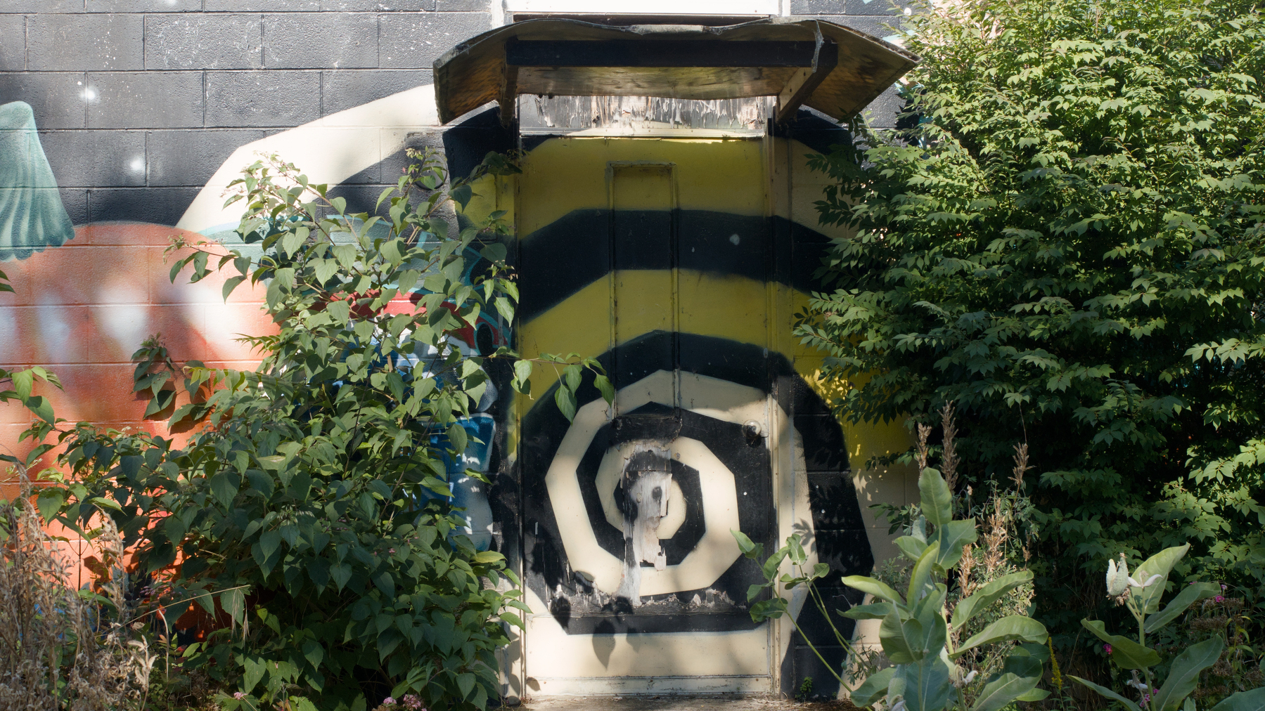 weathered door with a spiral painted on the front