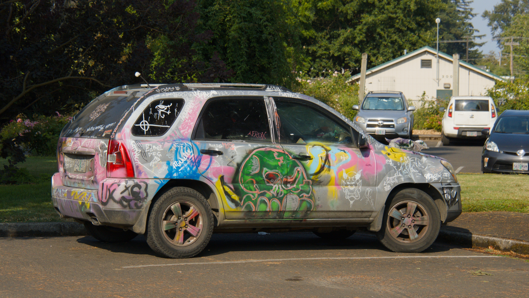 car covered in spray paint graffiti