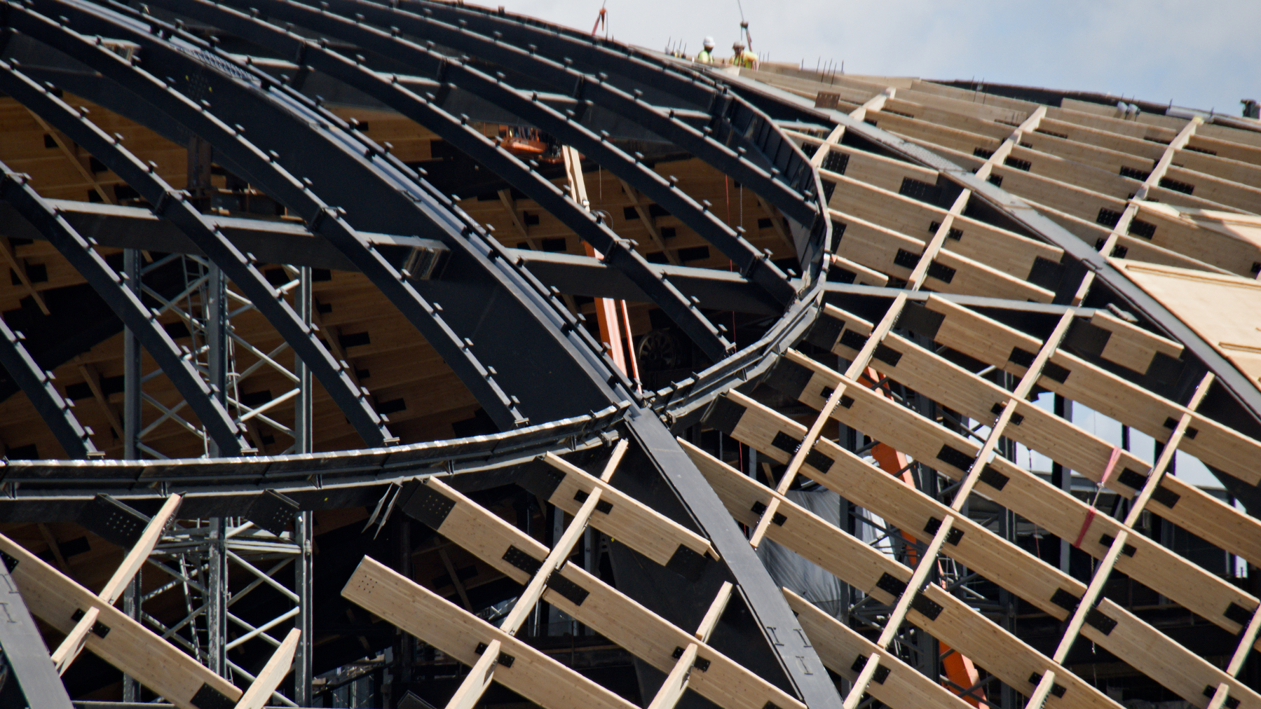 large dome being bolted together from steel and wood components