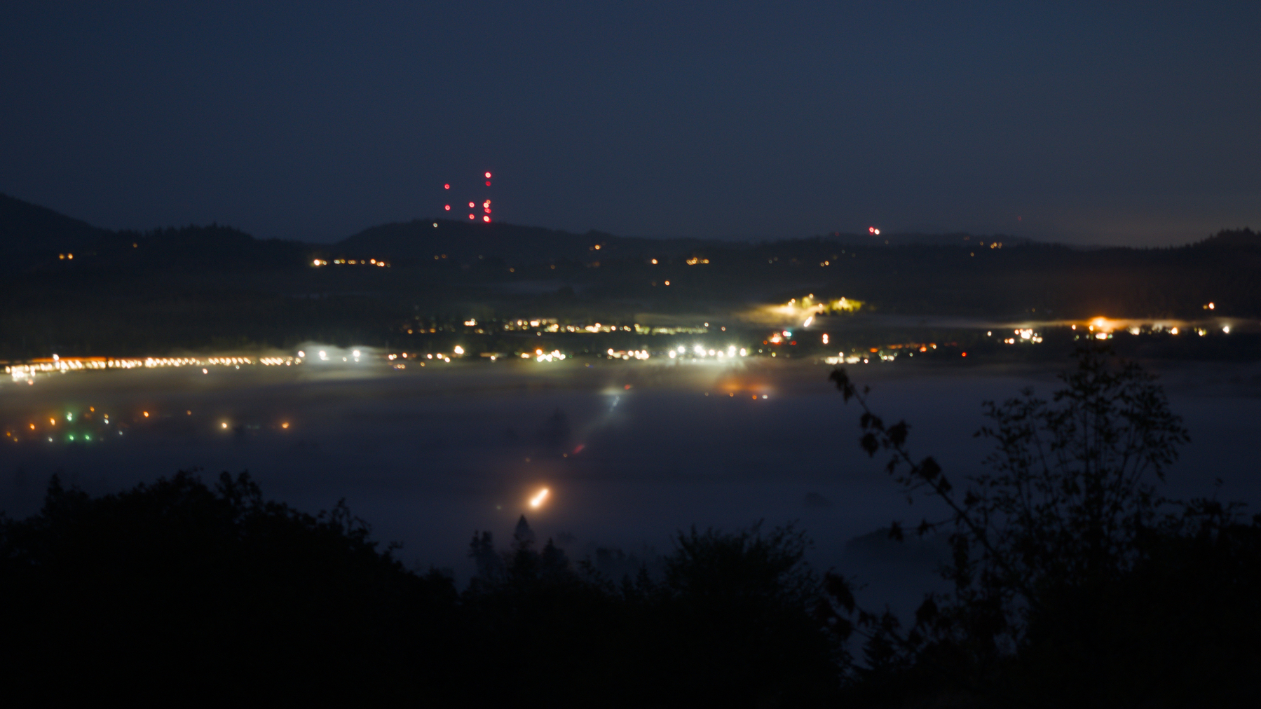 early morning long exposure with fog and city lights