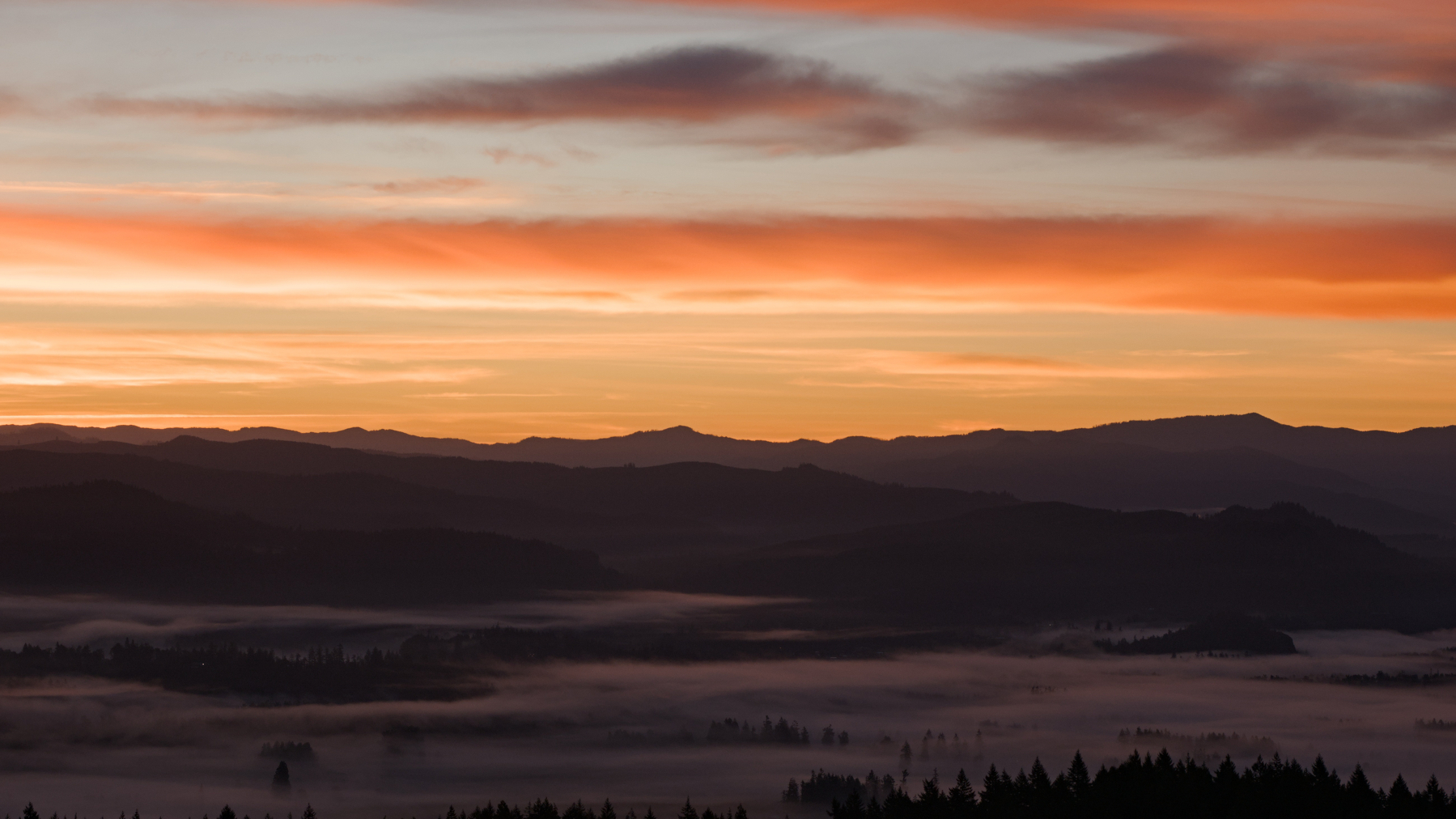 sunrise over foggy valleys