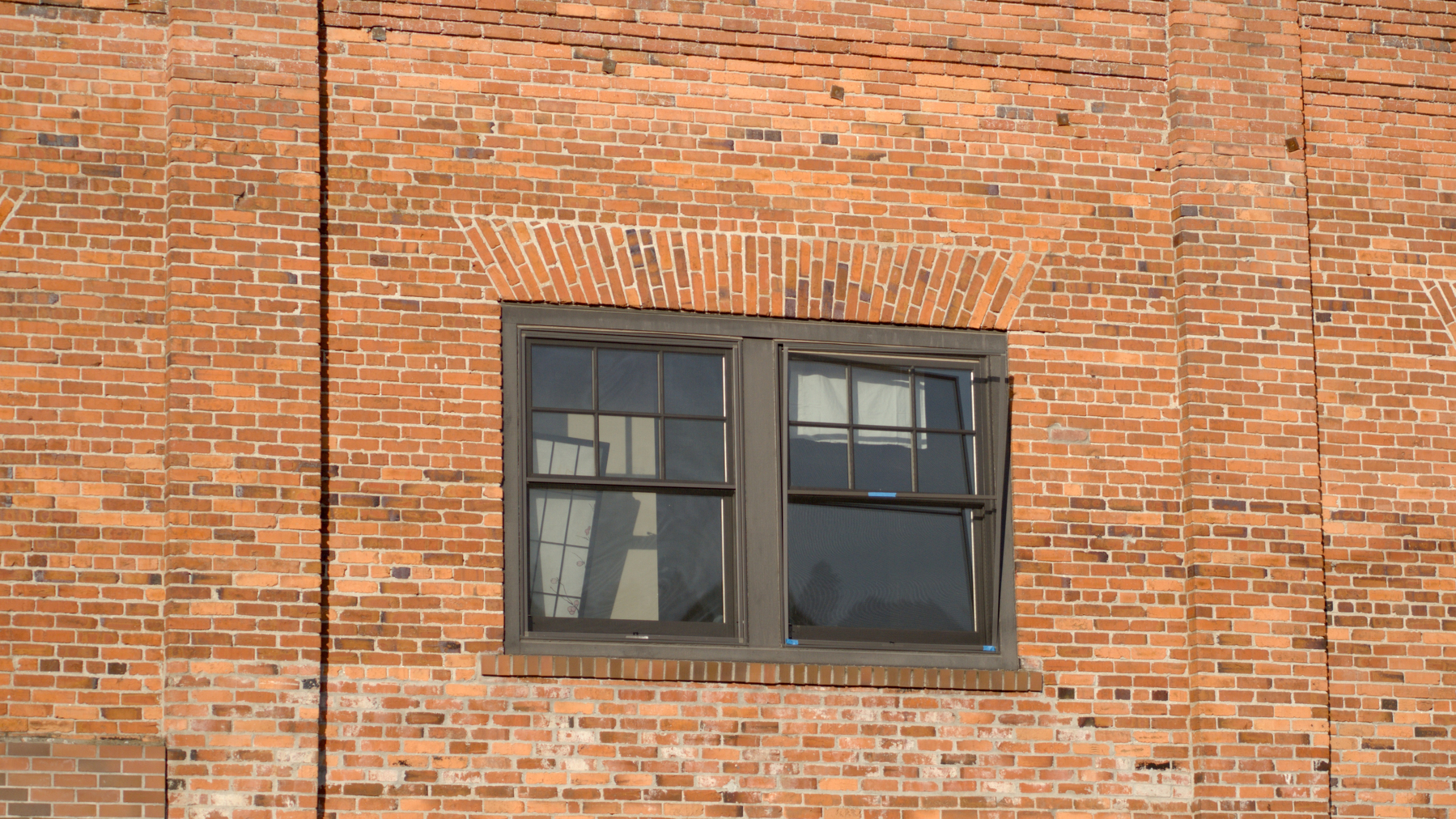 window in a brick wall with stuff inside