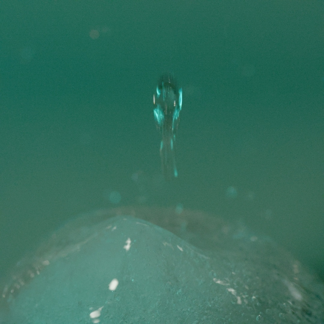 Water drop rebounding from an ice cube
