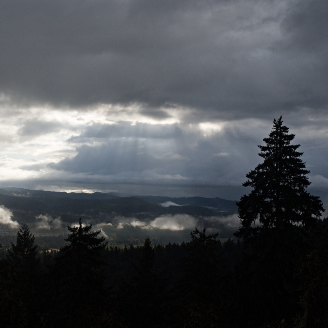 mountains with sunrays streaming through the clouds