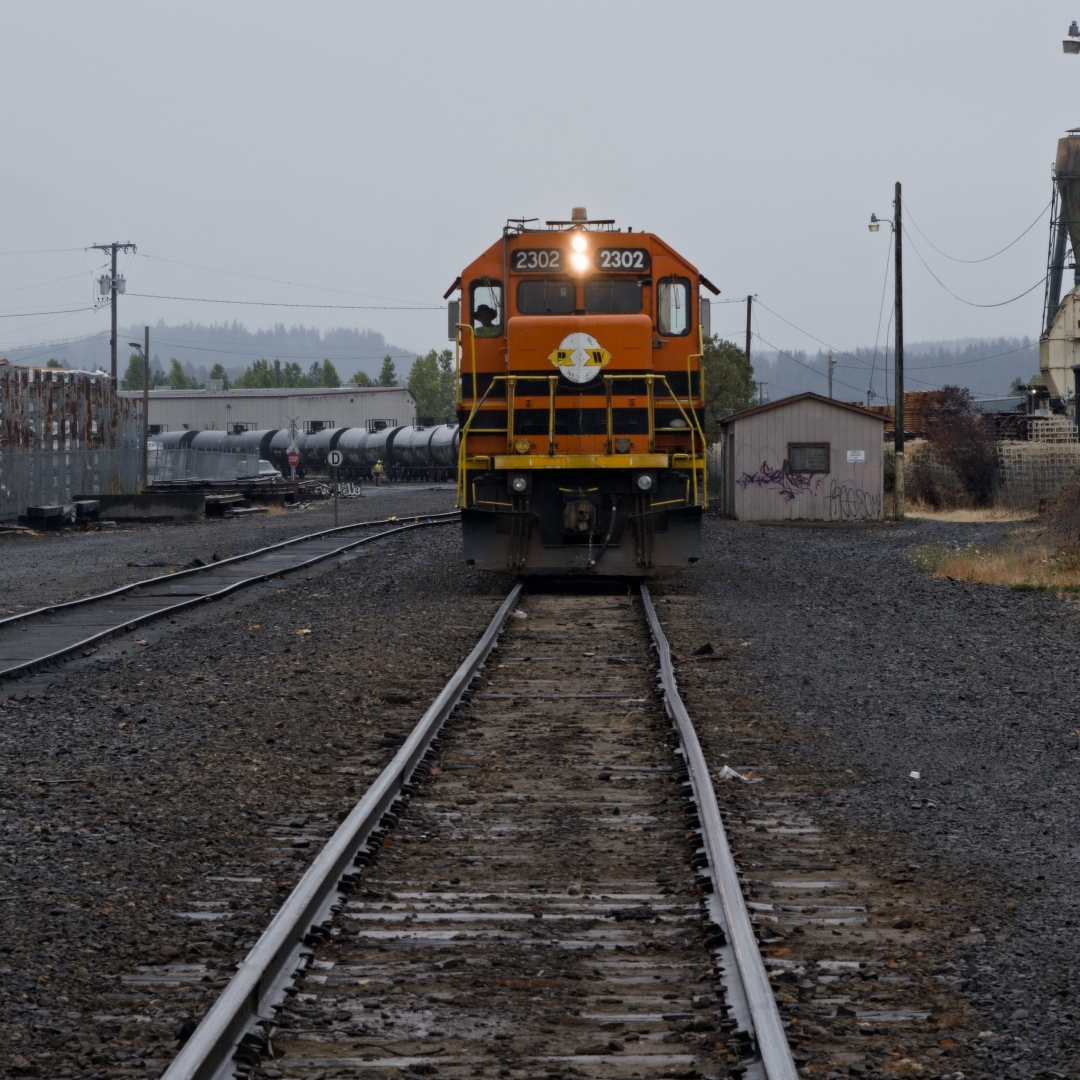 train with its headlight on coming down the tracks