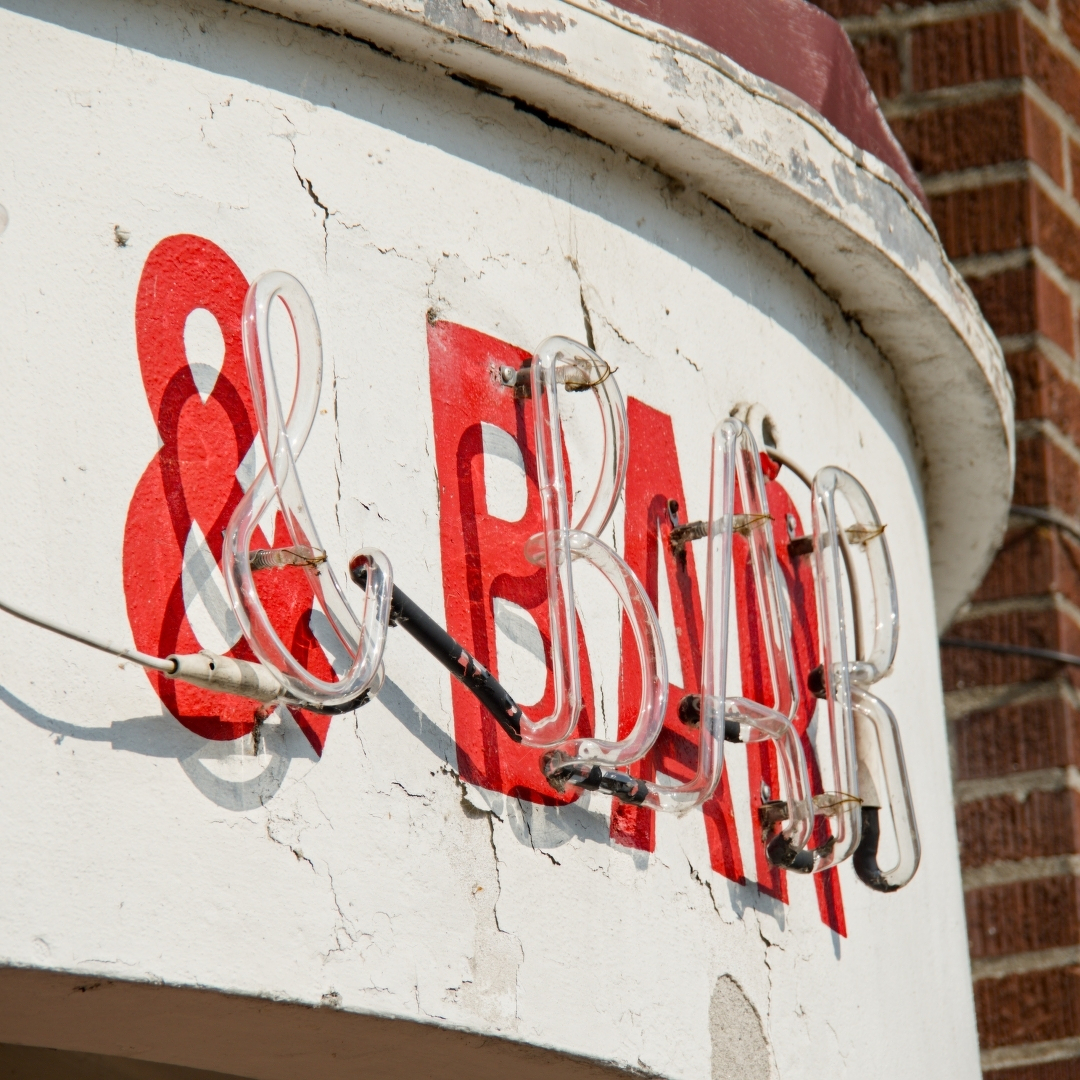 & BAR in red on a white background with unlit neon tube on top