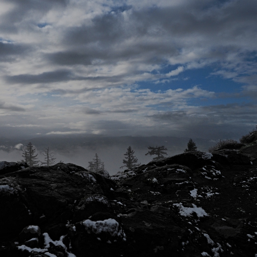 Rocky top with snow and dramatic clouds