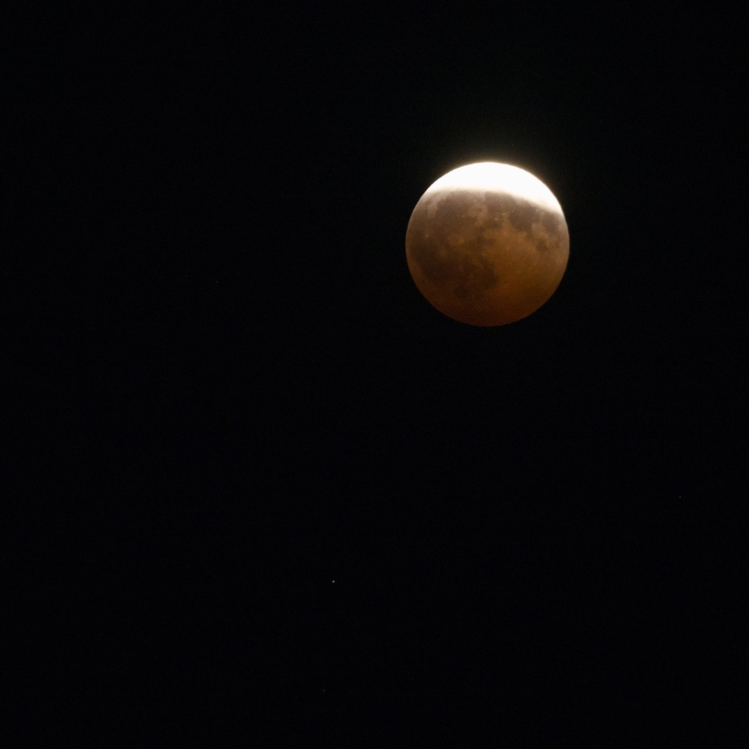 Mostly red moon during a partial lunar eclipse