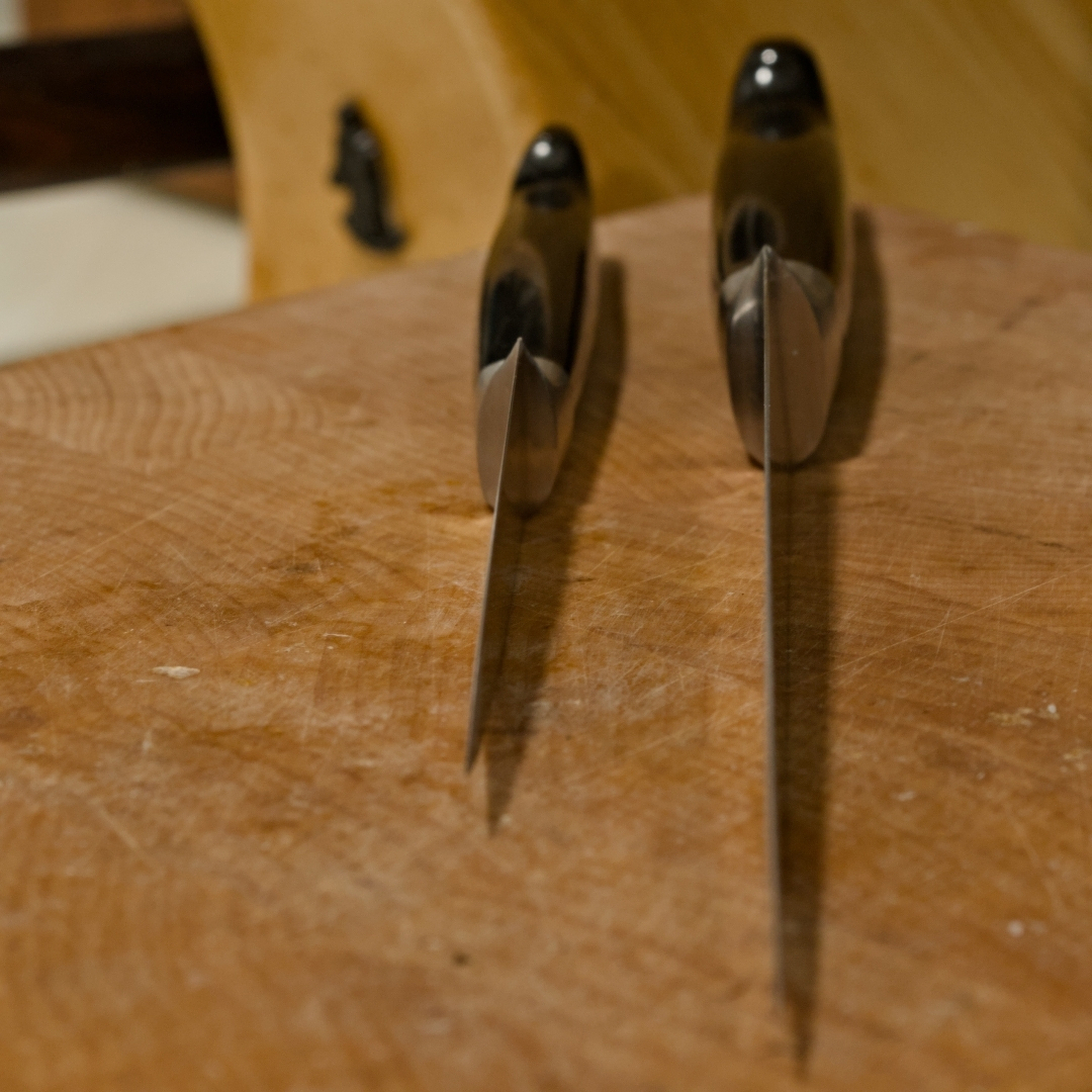 two knives on a cutting board