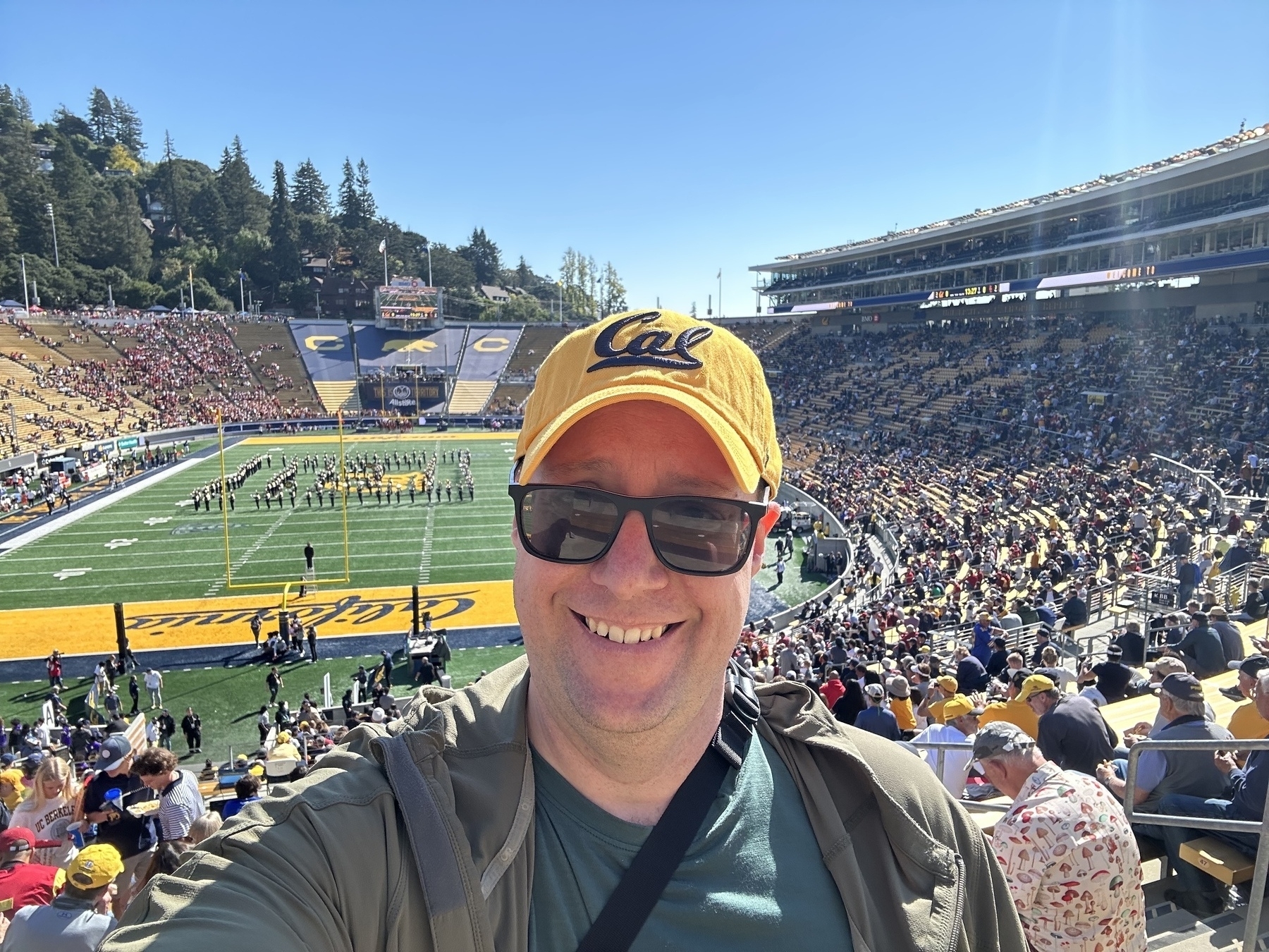 Selfie of the author wearing a gold Cal hat at CAlifornia Memorial Stadium. 