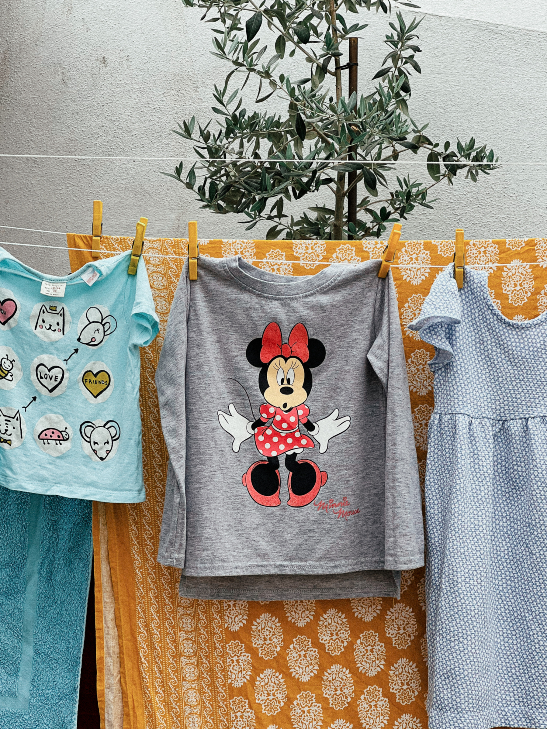 a shirt with Minnie Mouse hangs out to dry