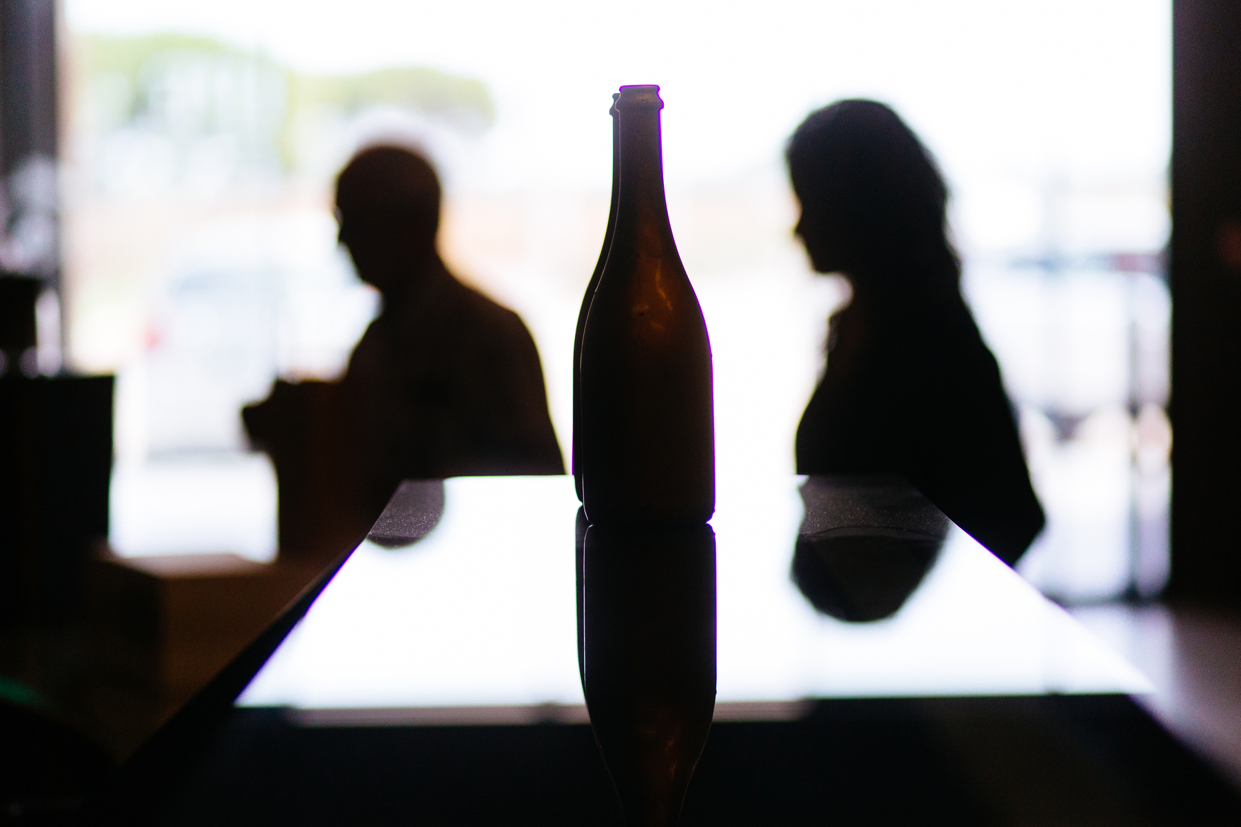 Silhouettes, bottle and two persons 