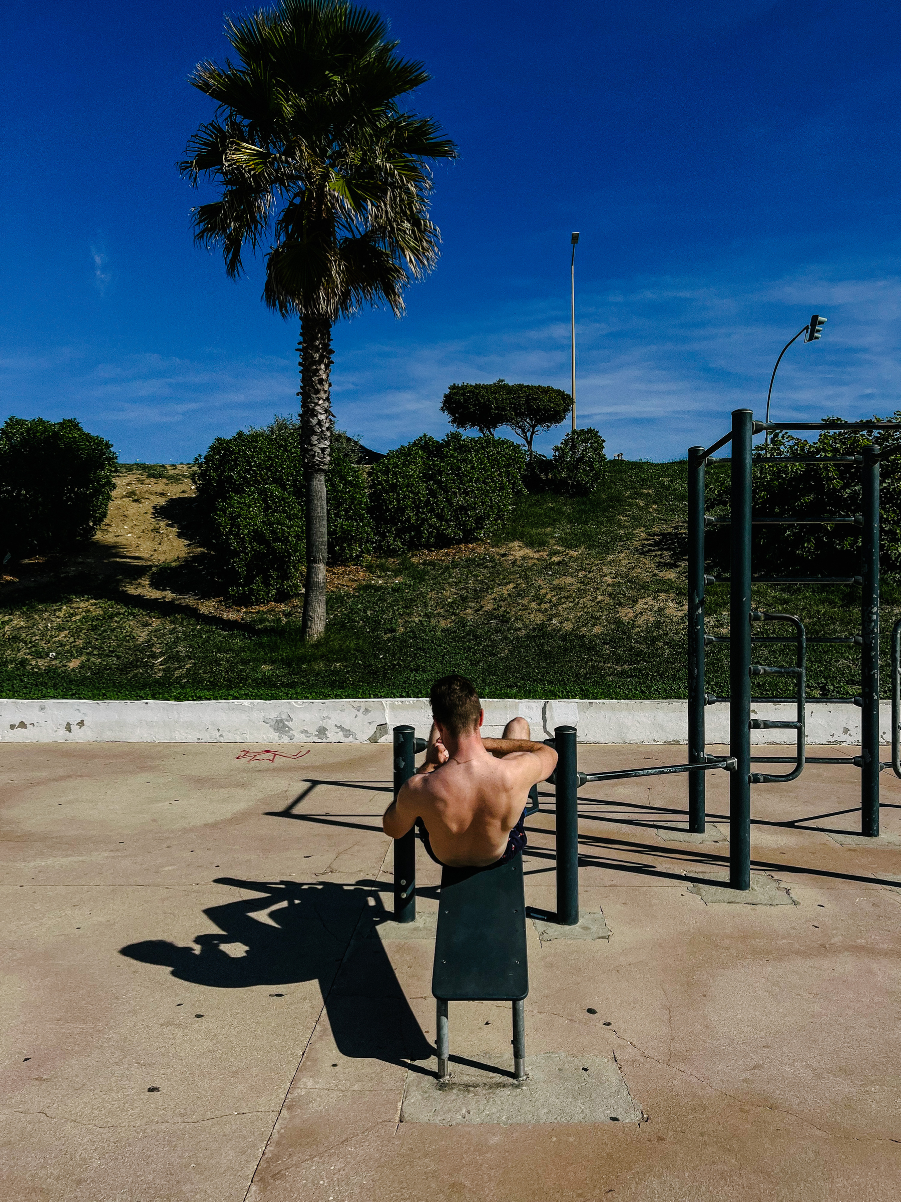 A man exercises at the beach