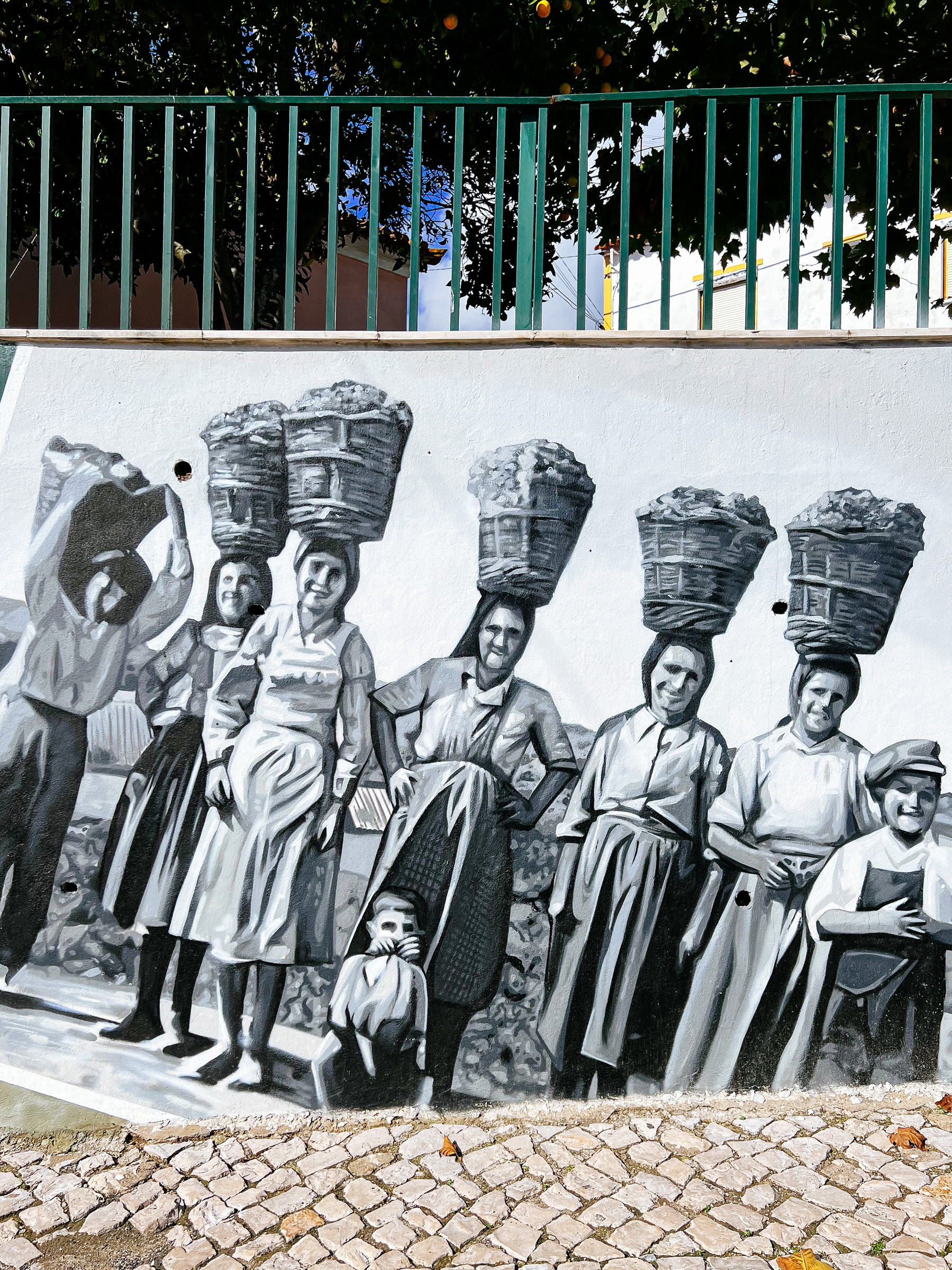 Street art, women carrying grapes on their heads. 