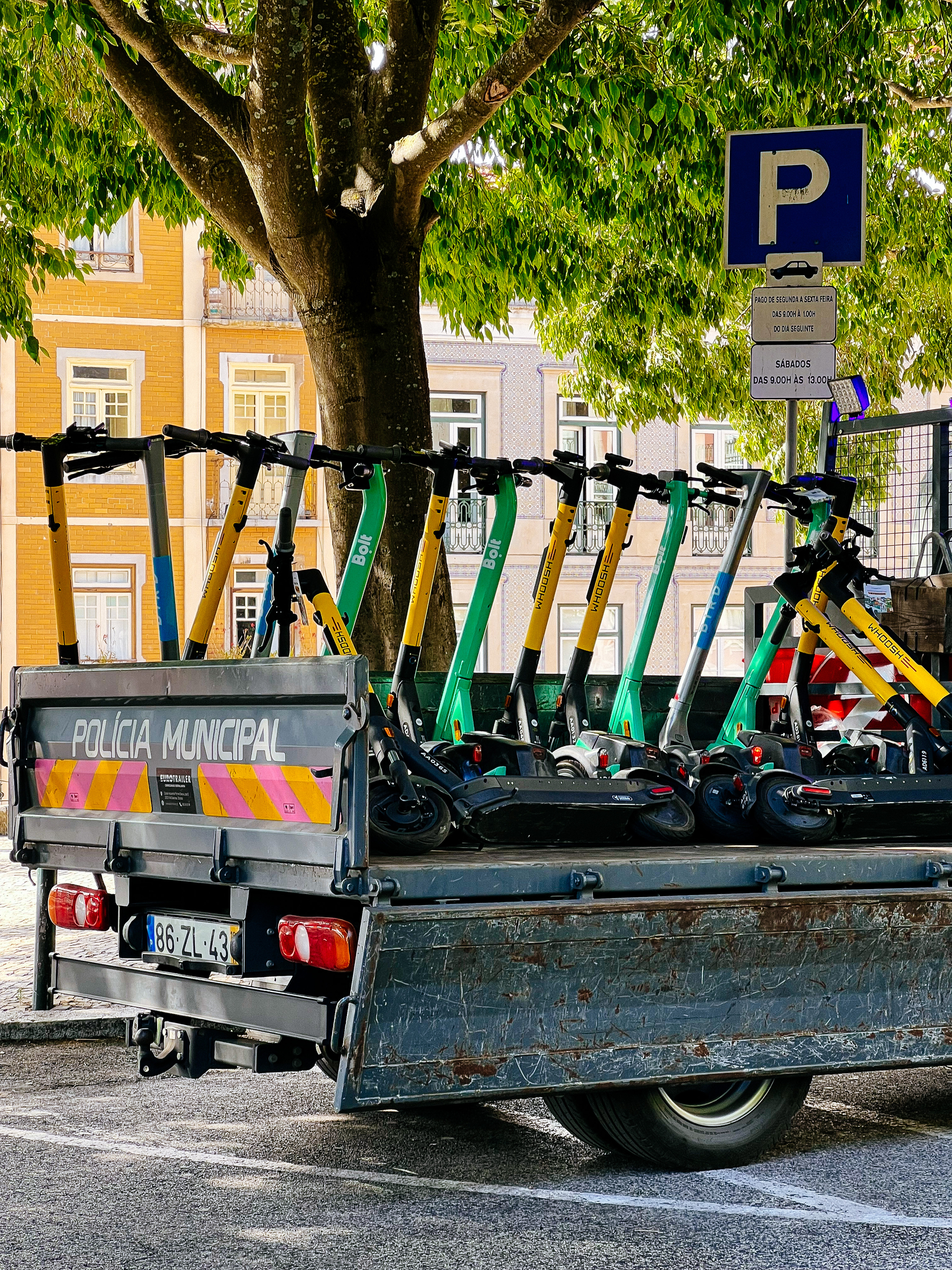 scooters being carried away on a police truck