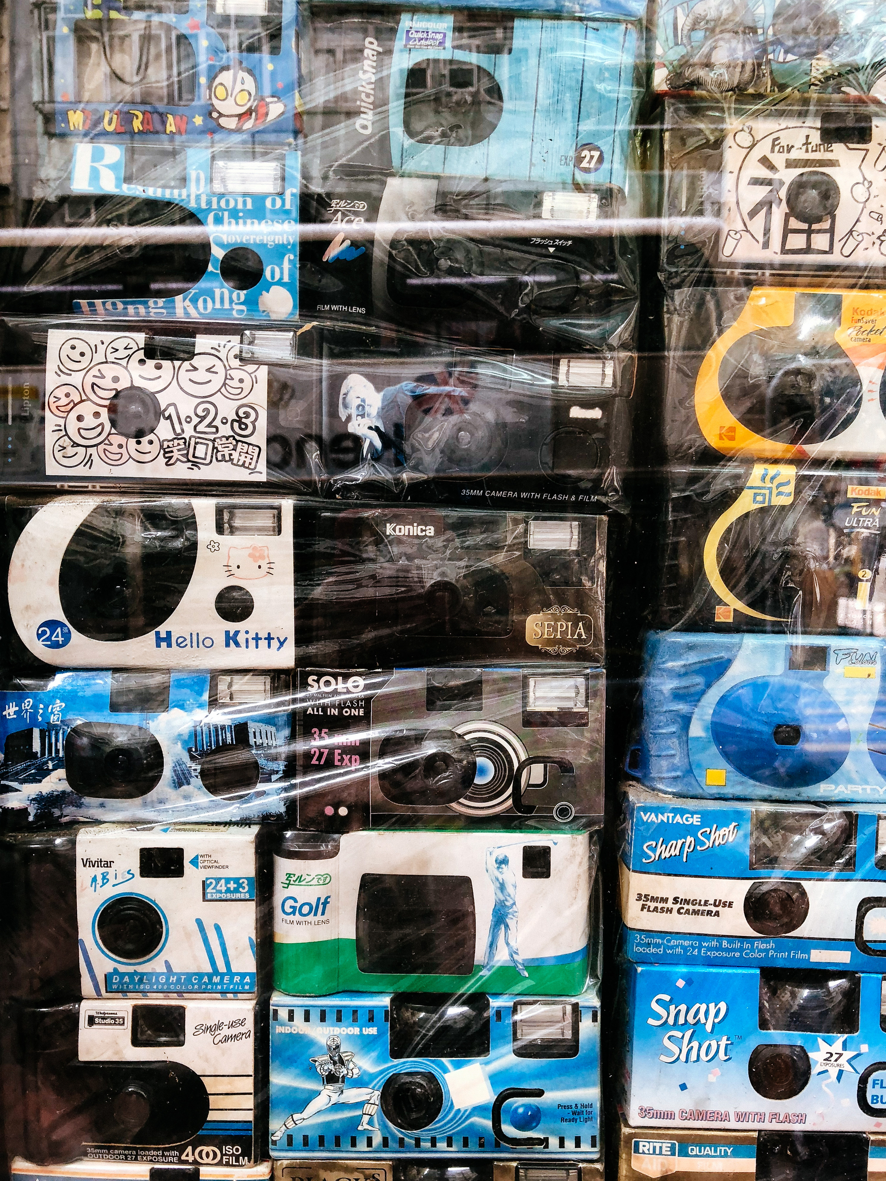 A wall of disposable cameras. In there, somewhere, there’s one with Hello Kitty branding.