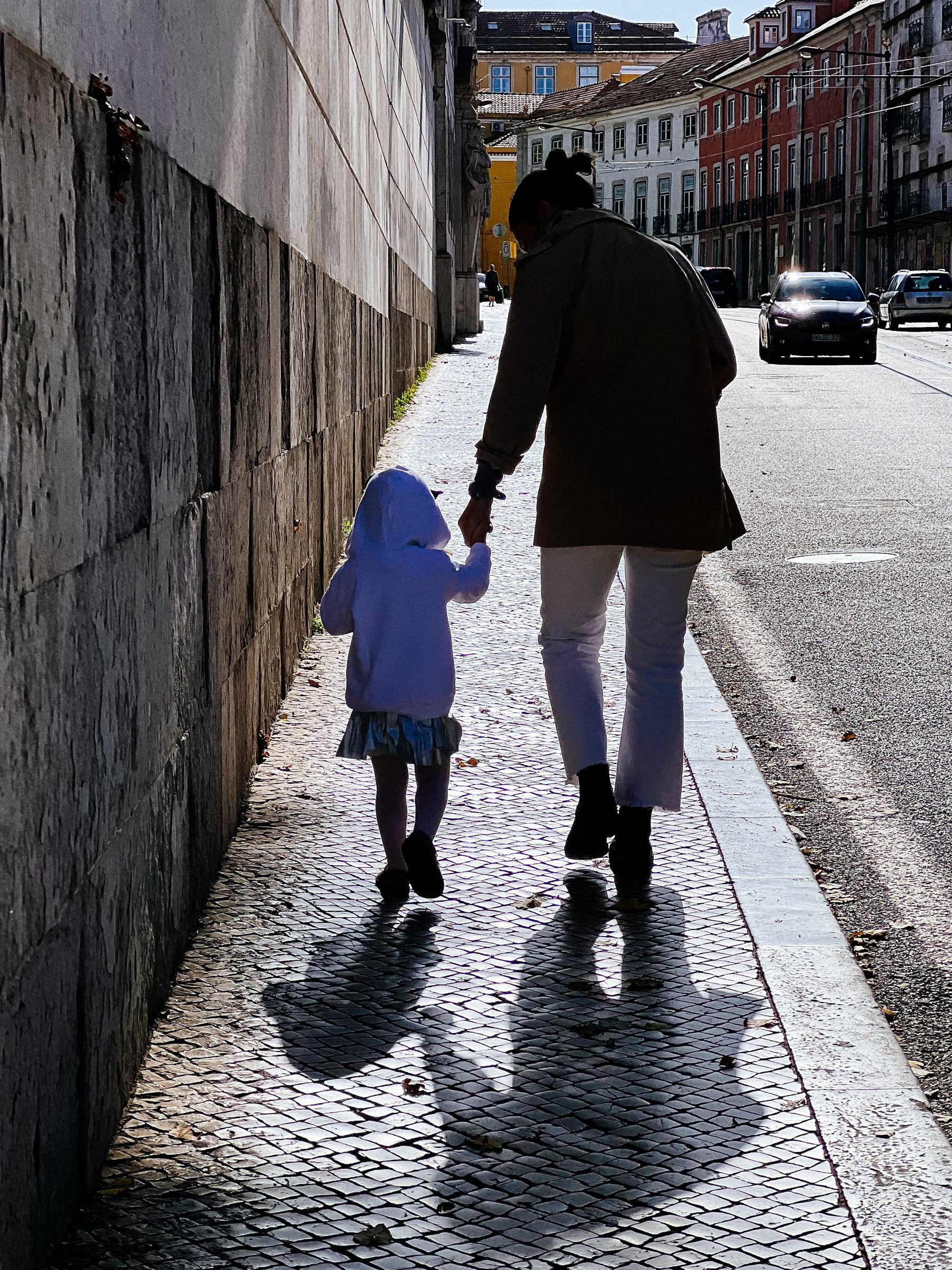 mother and daughter, walking down the street