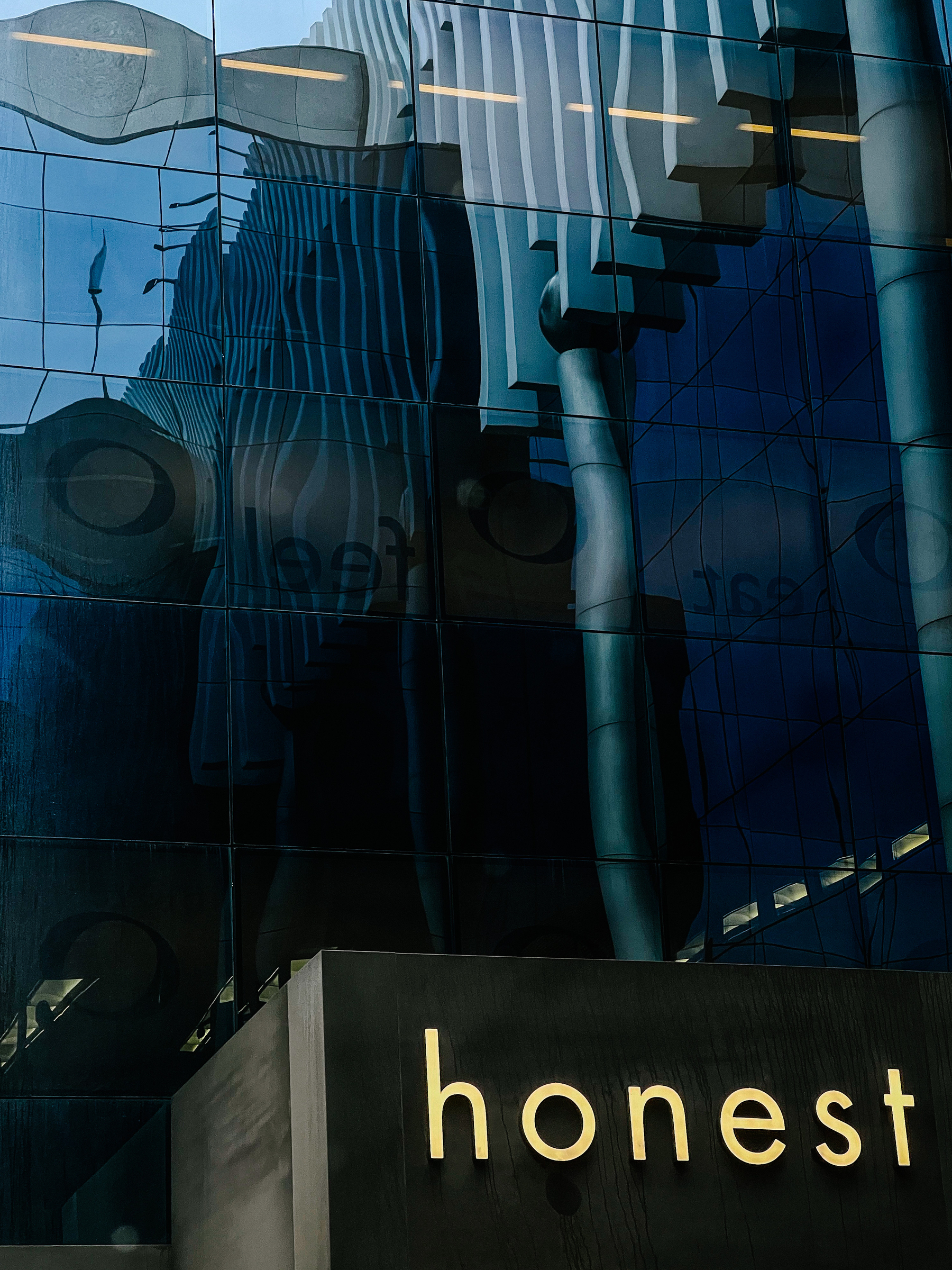 a modern building with the word “honest” in lights