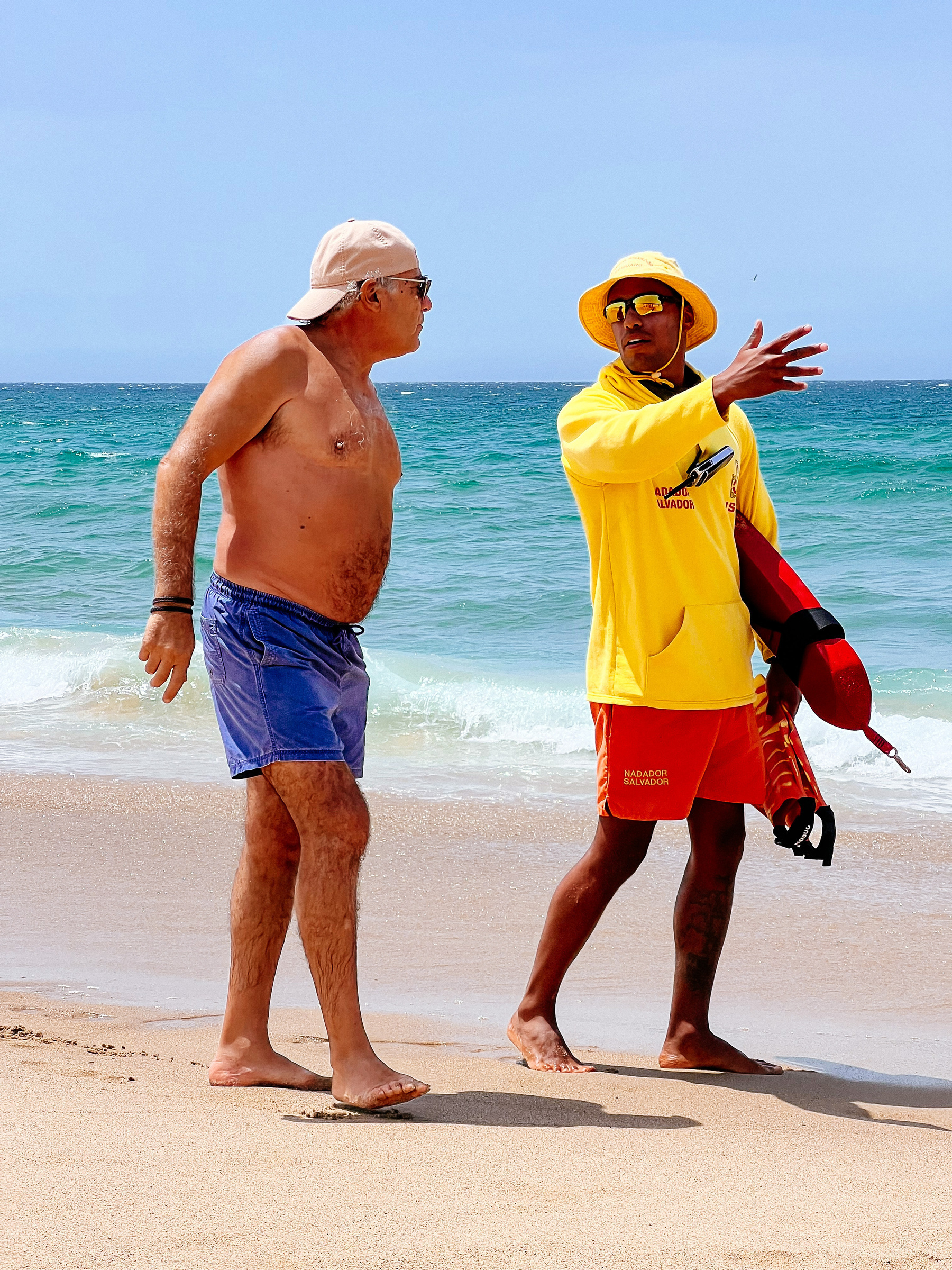 Lifeguard talks to a beach goer. 