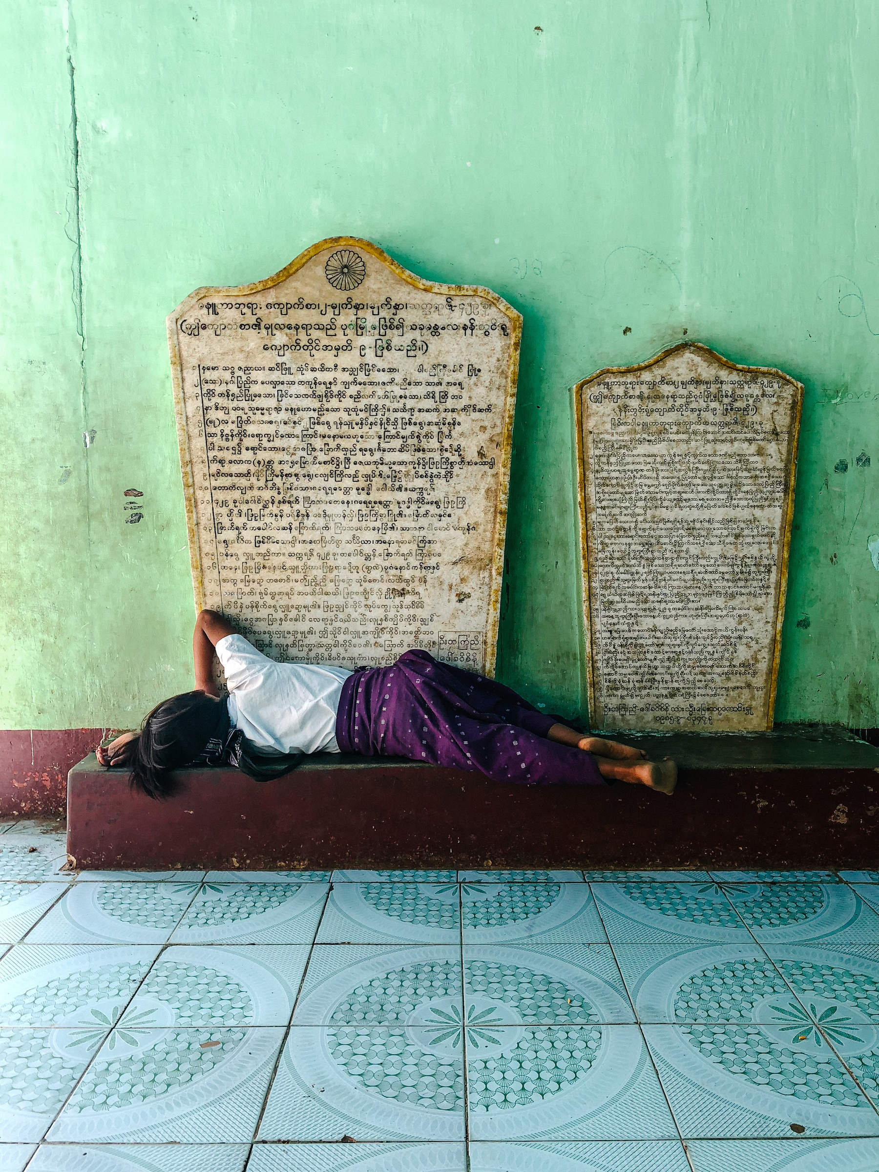 a girl sleeps inside a temple