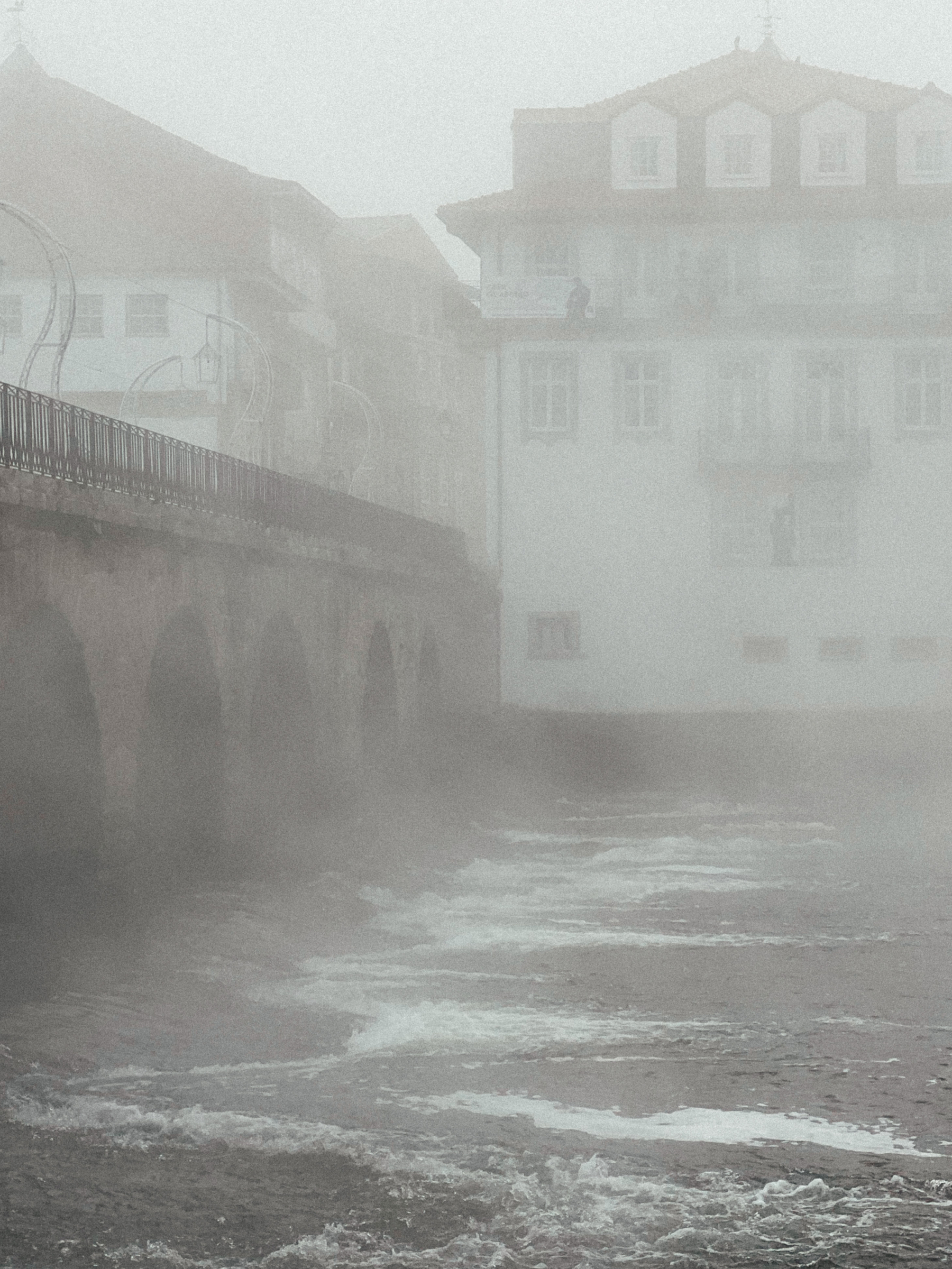 Roman bridge in a river, during a misty morning. 