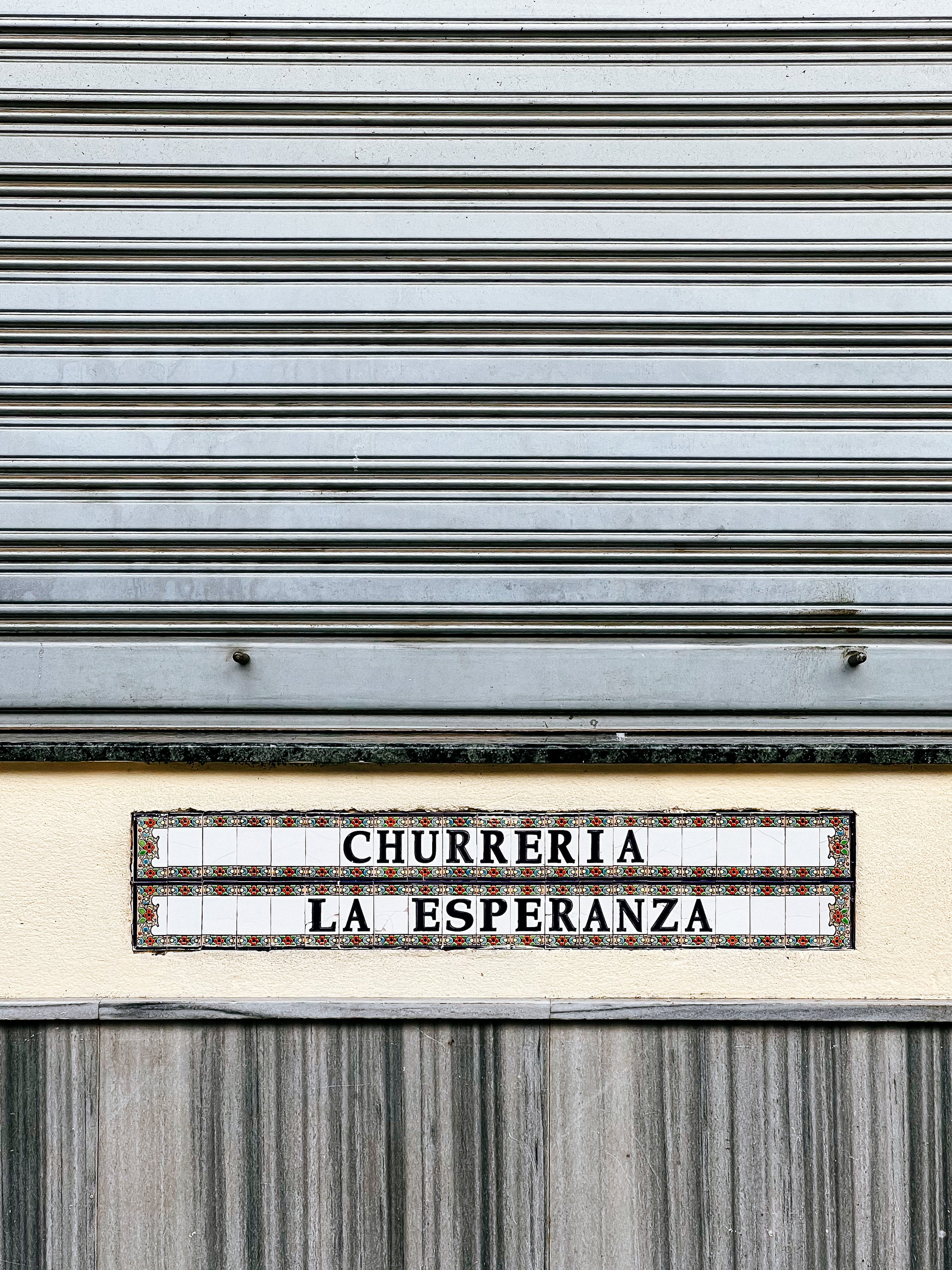 a store front, “churreria” written on it