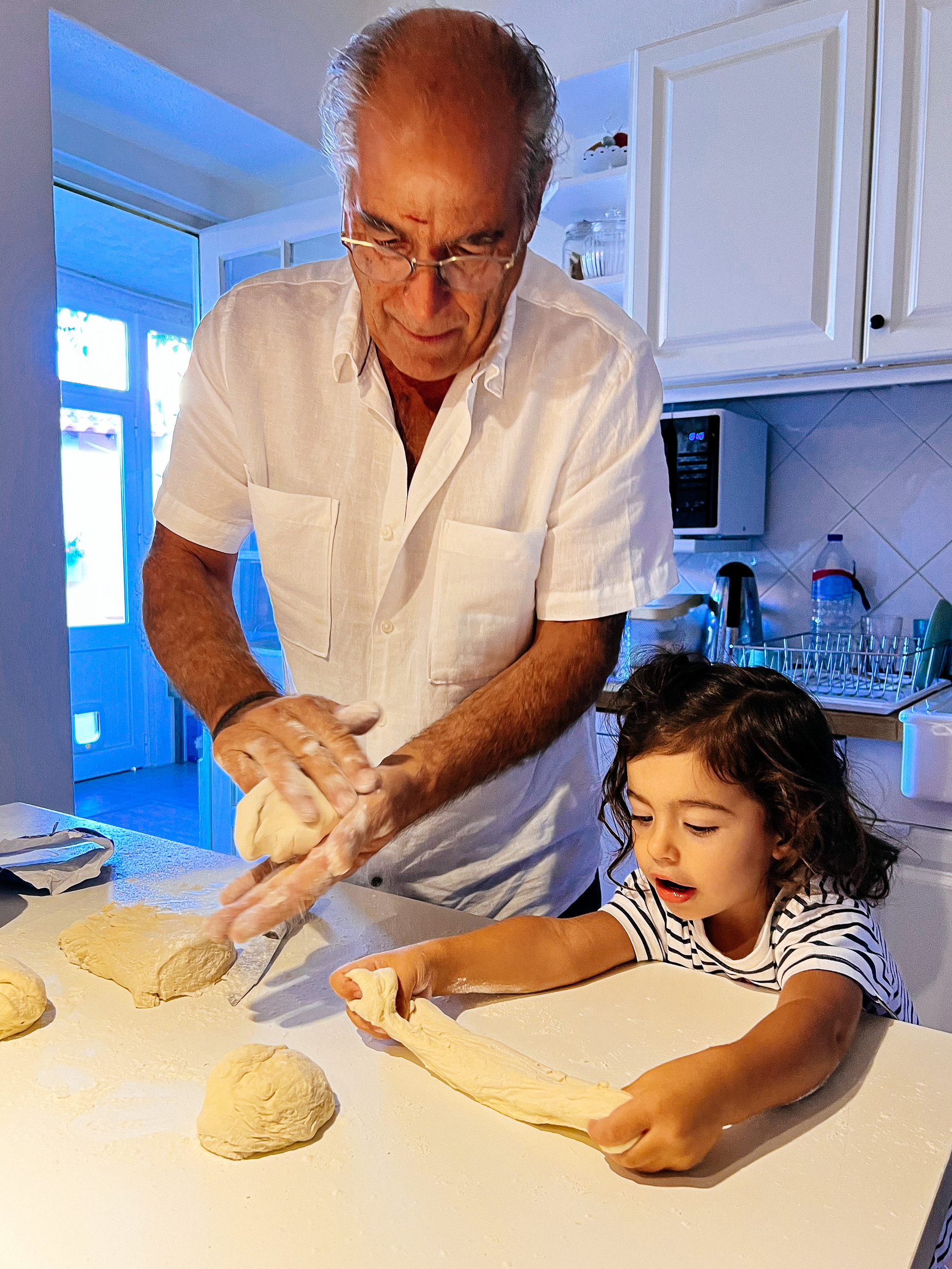 toddler with grandpa making pizza