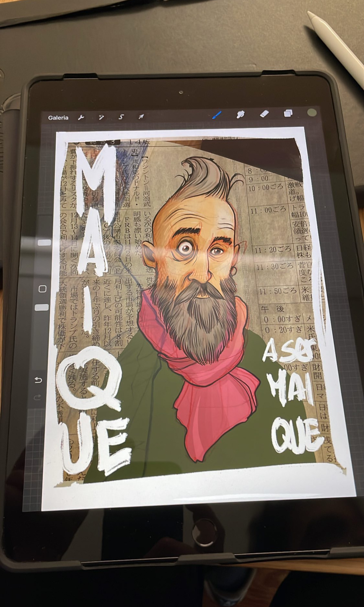 iPad with a drawing of a bearded guy with a pink scarf. The word “maique” is visible. 