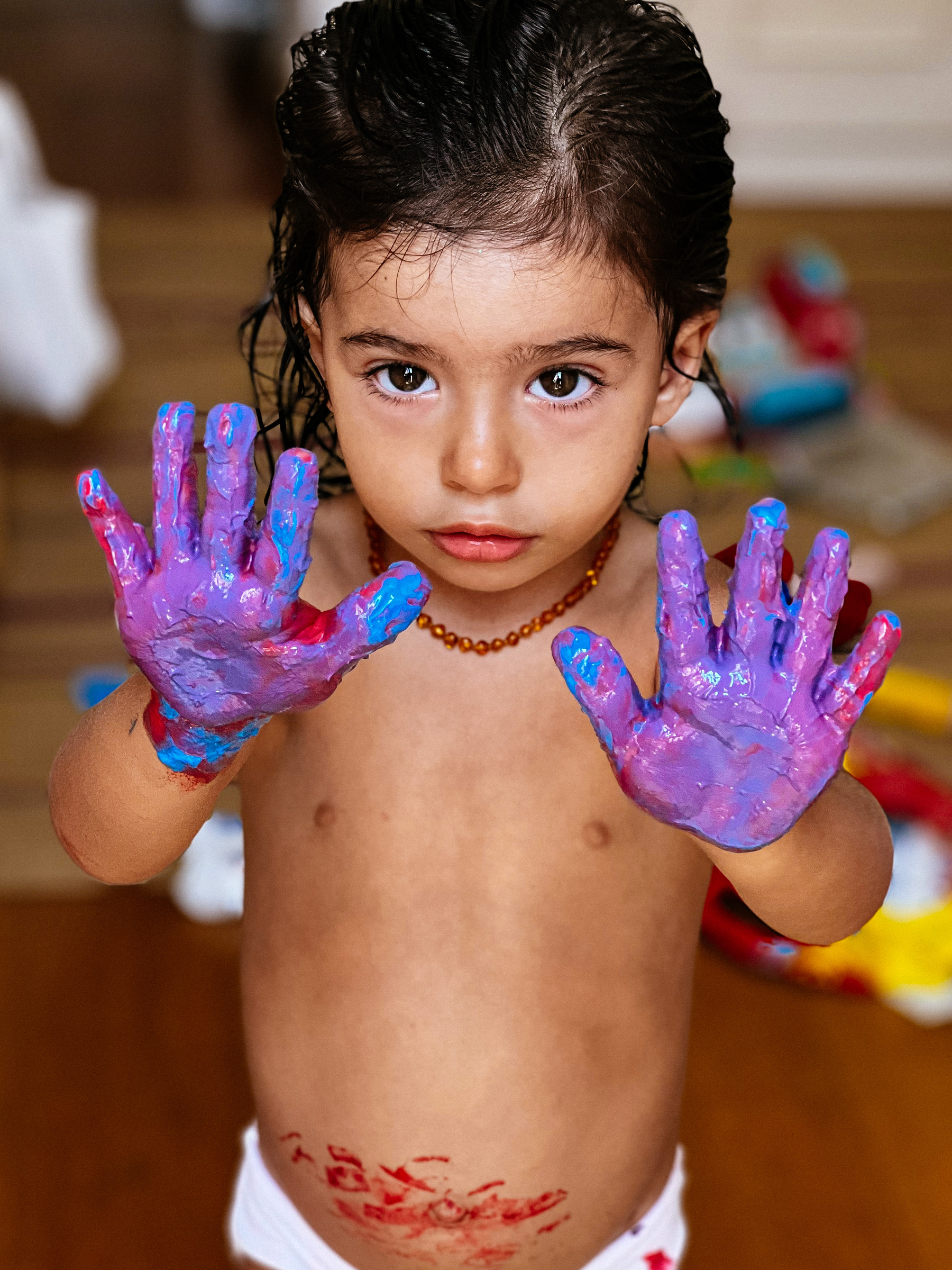 Toddler shows off her paint covered hands