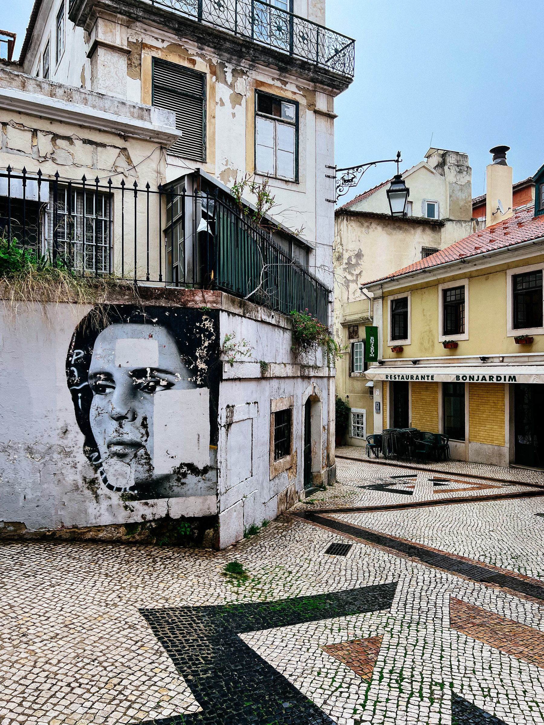A portrait of Amália, the fado singer, is graffitied on a wall