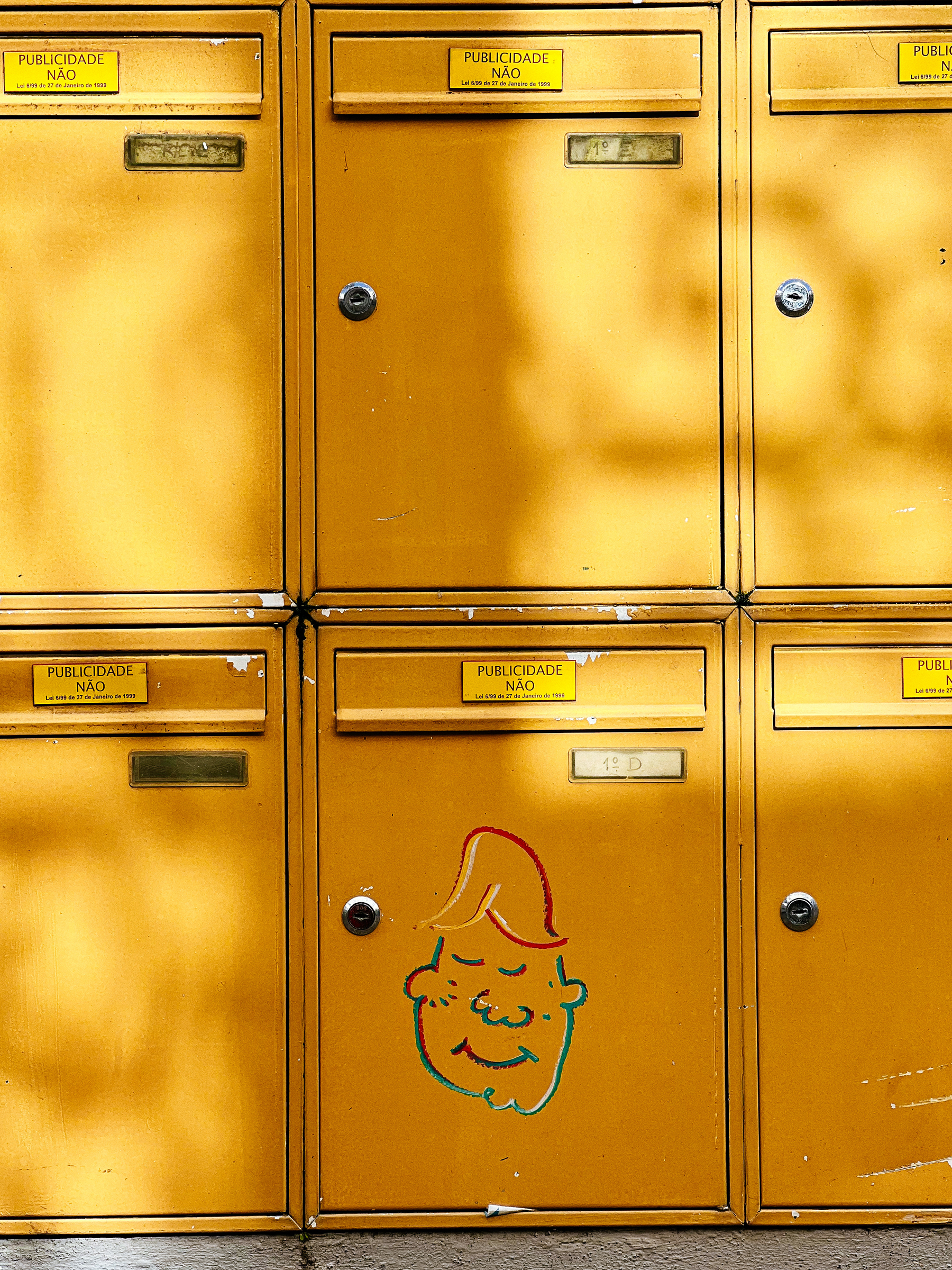 Yellow mailboxes with a drawing in one of them 