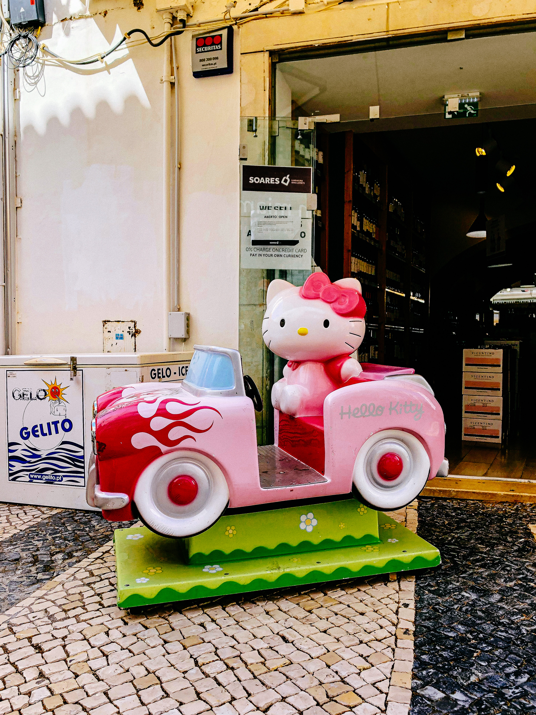 I have absolutely no idea what these are called in English, but it’s a coin operated car, that rocks back and forth for a while. There an Hello Kitty riding along. 