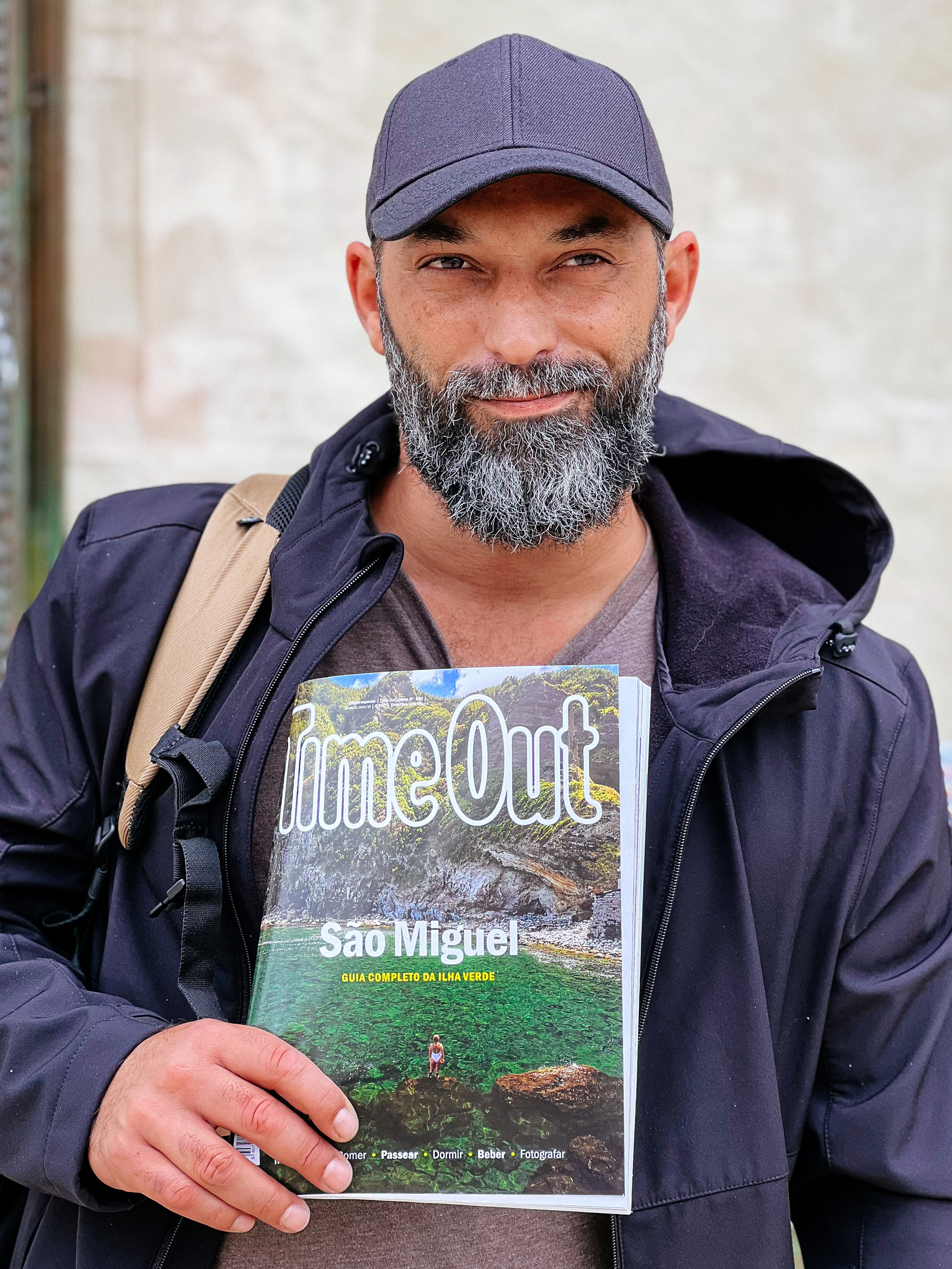 a bearded dude holding a magazine