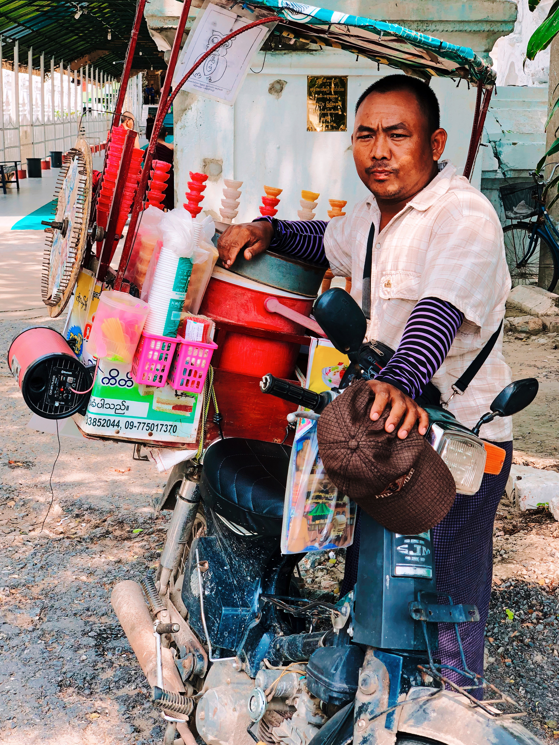 An ice-cream seller, with his motorcycle. 
