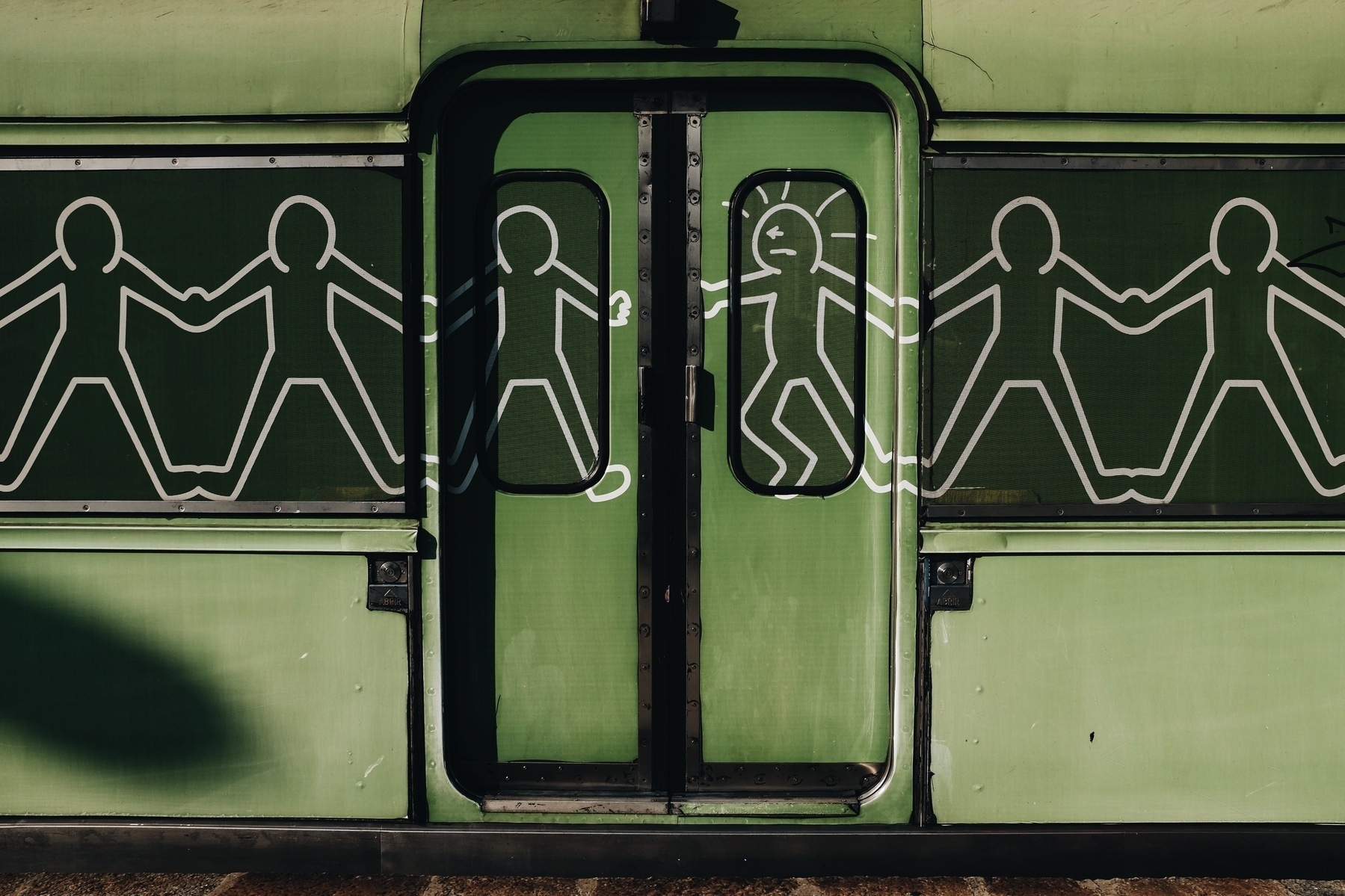 A train is painted in very low-cost Keith Haring style.