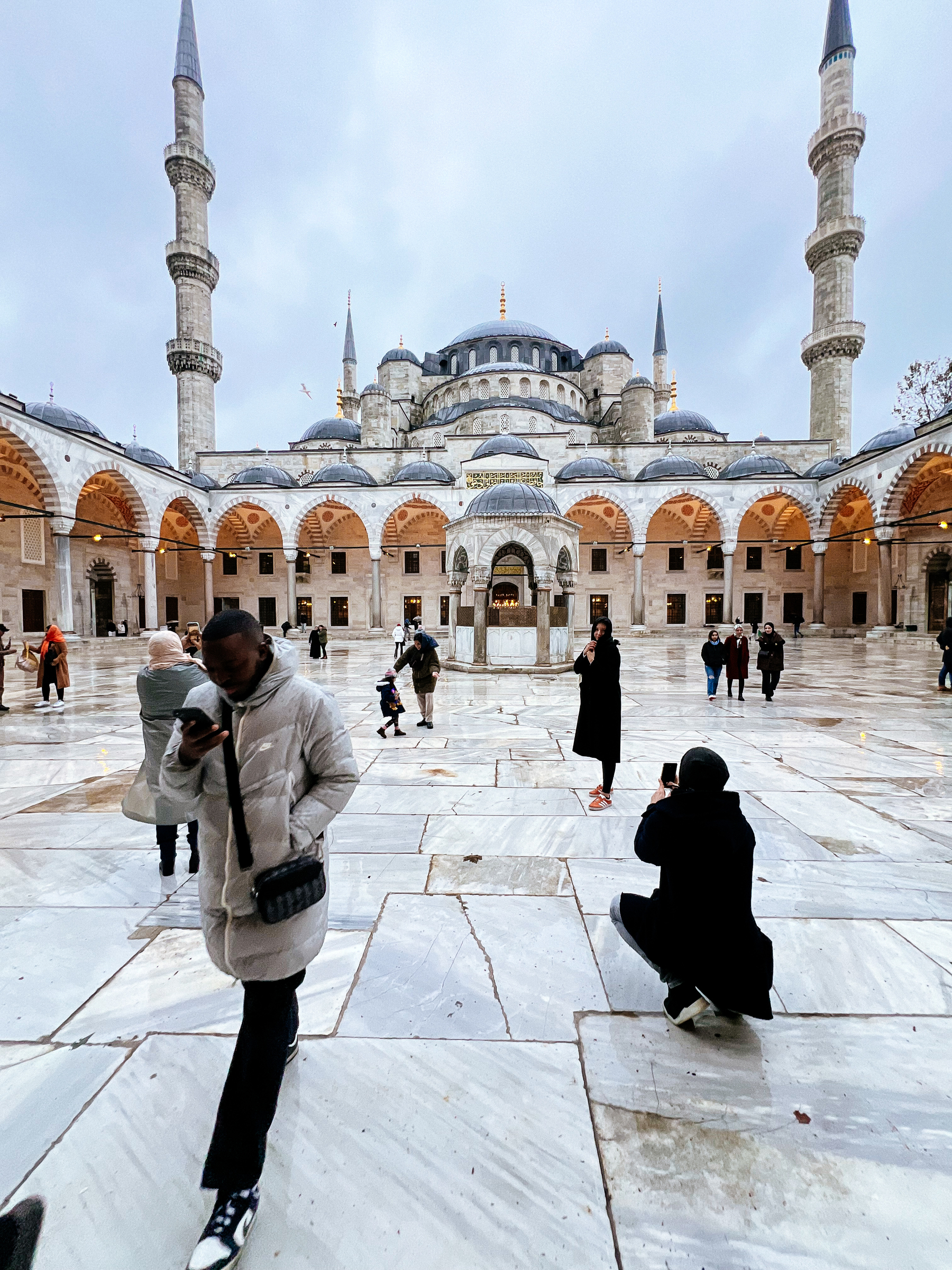 People take photos outside the Blue Mosque. 