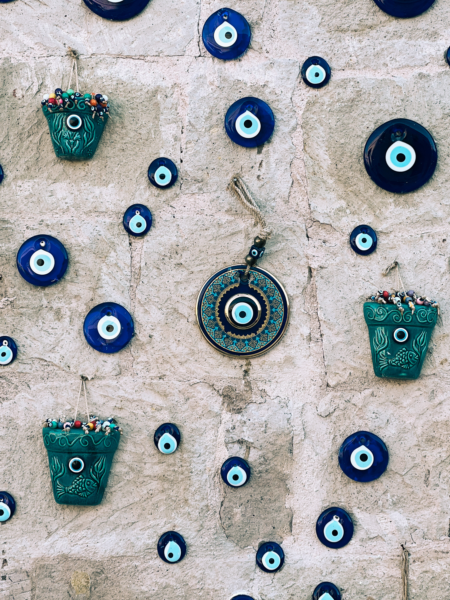 A wall with multiple ceramic “eye” pieces stuck to it. The eye thing is supposed to keep evil spirits away. 