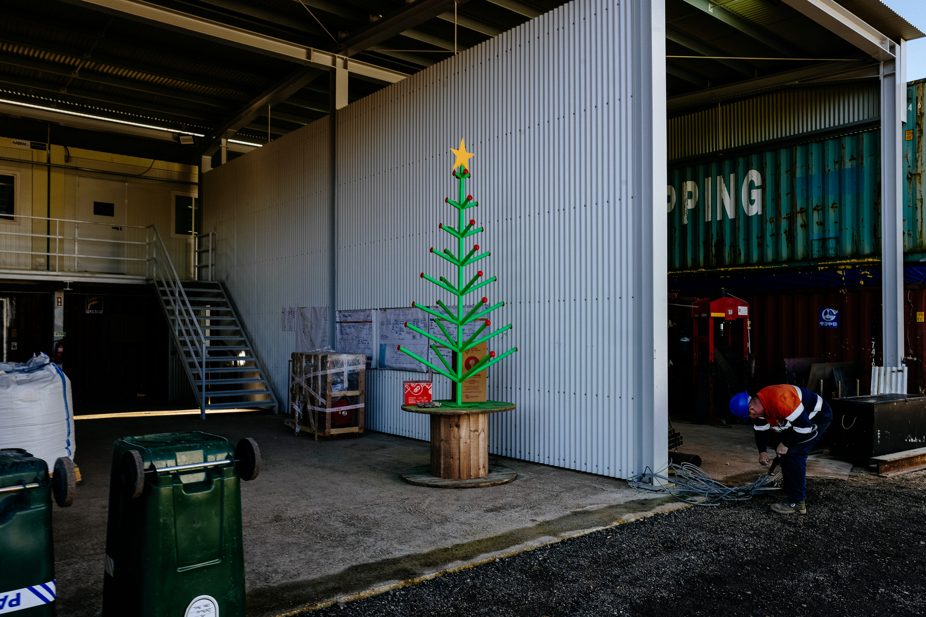 A rough, simple, Christmas tree. In the middle of a construction site. 