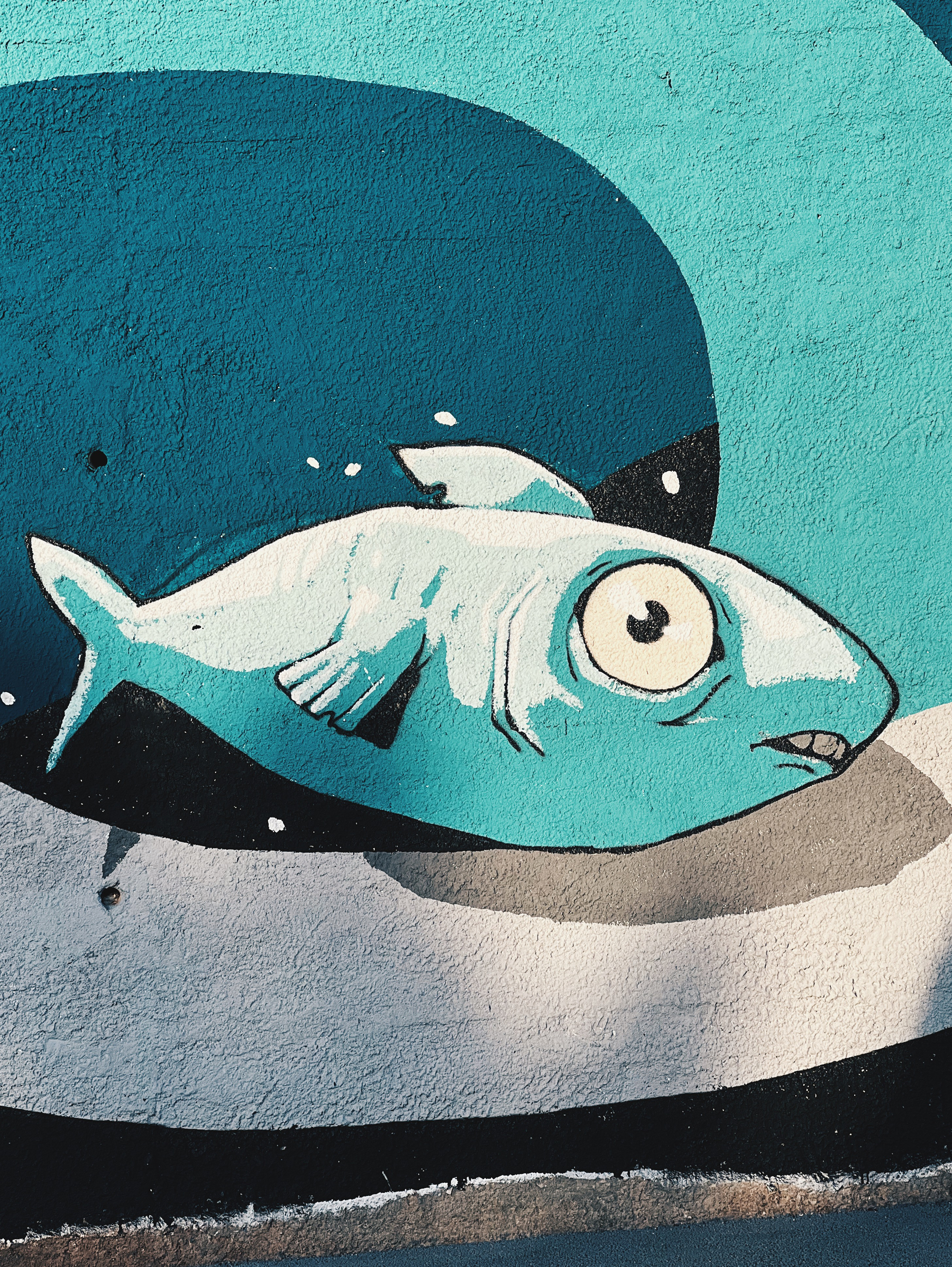 A part of a street art piece, a graffitied fish. 