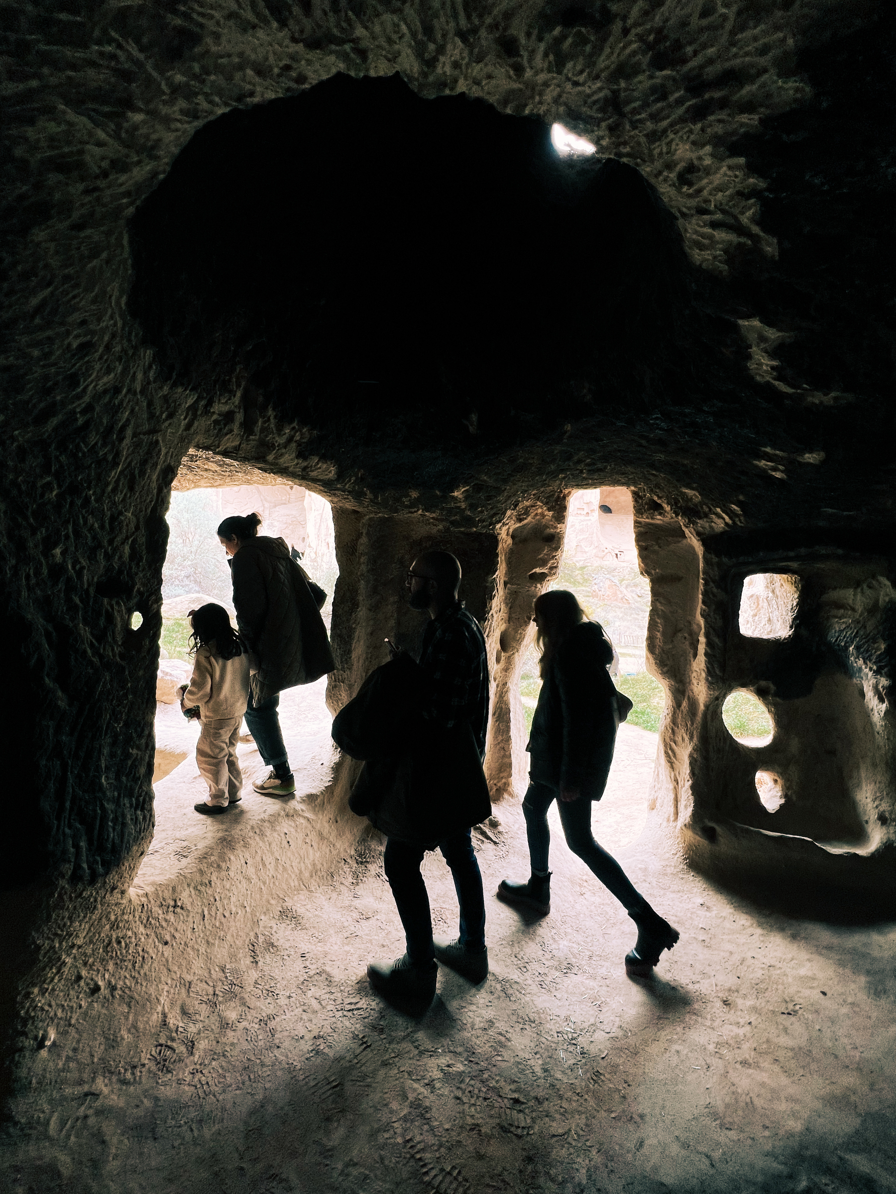 People walk in a cavern.