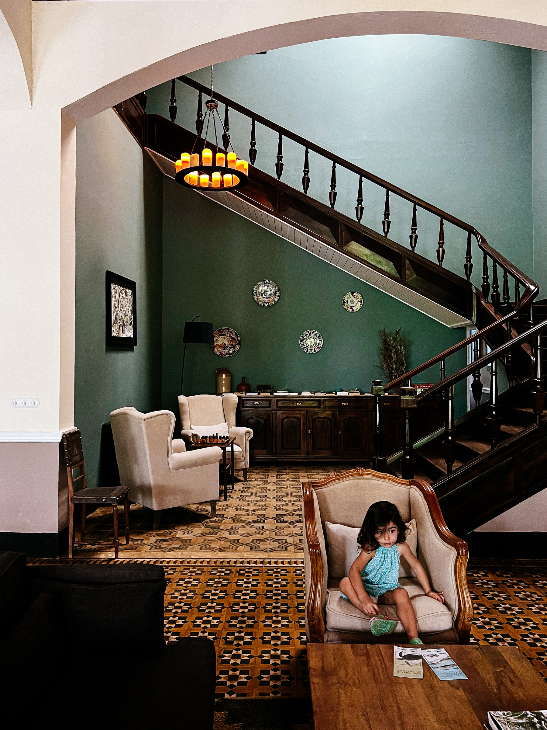 A toddler sits on the lobby of an hotel, an old plantation house. Classy. 