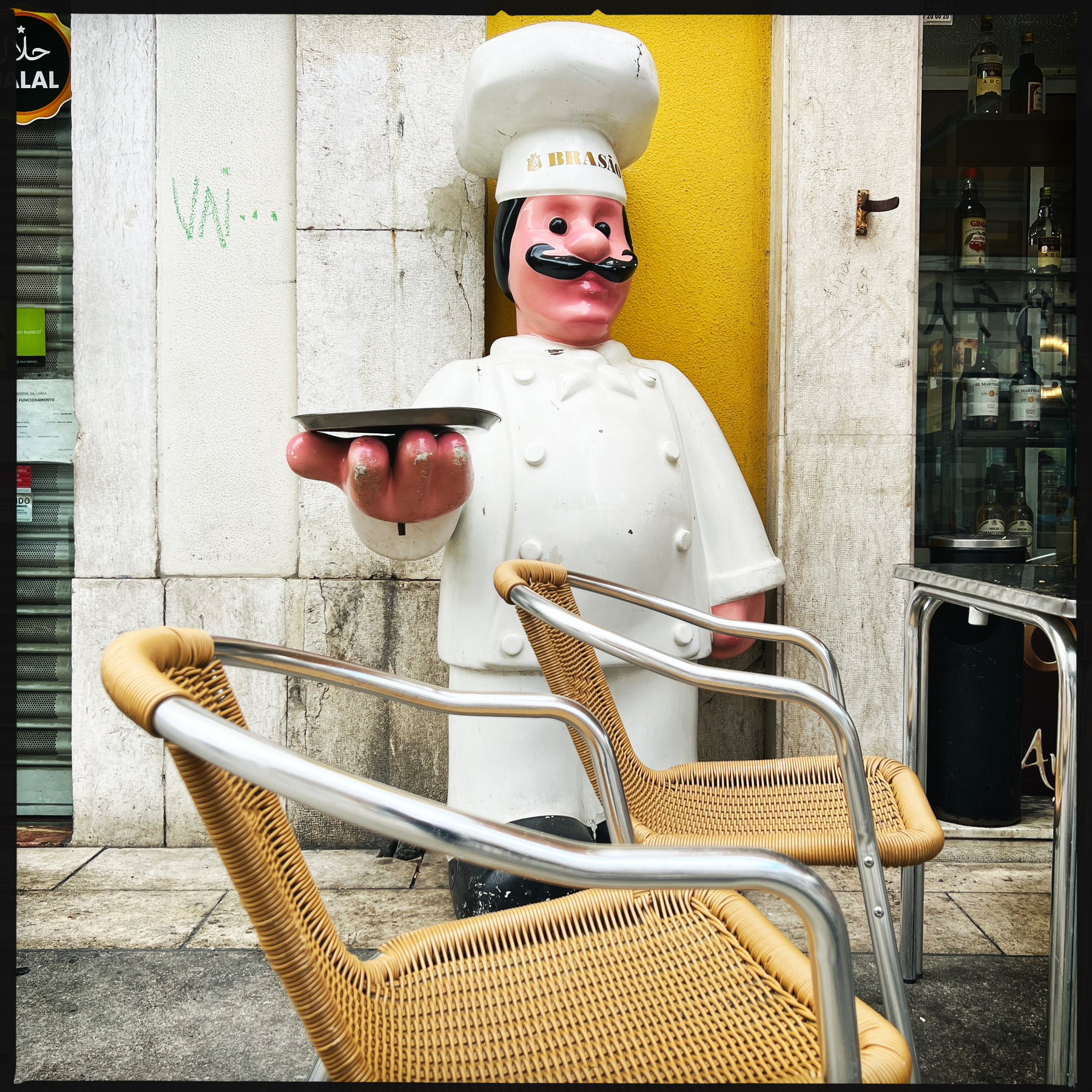 A chef’s doll outside a café.