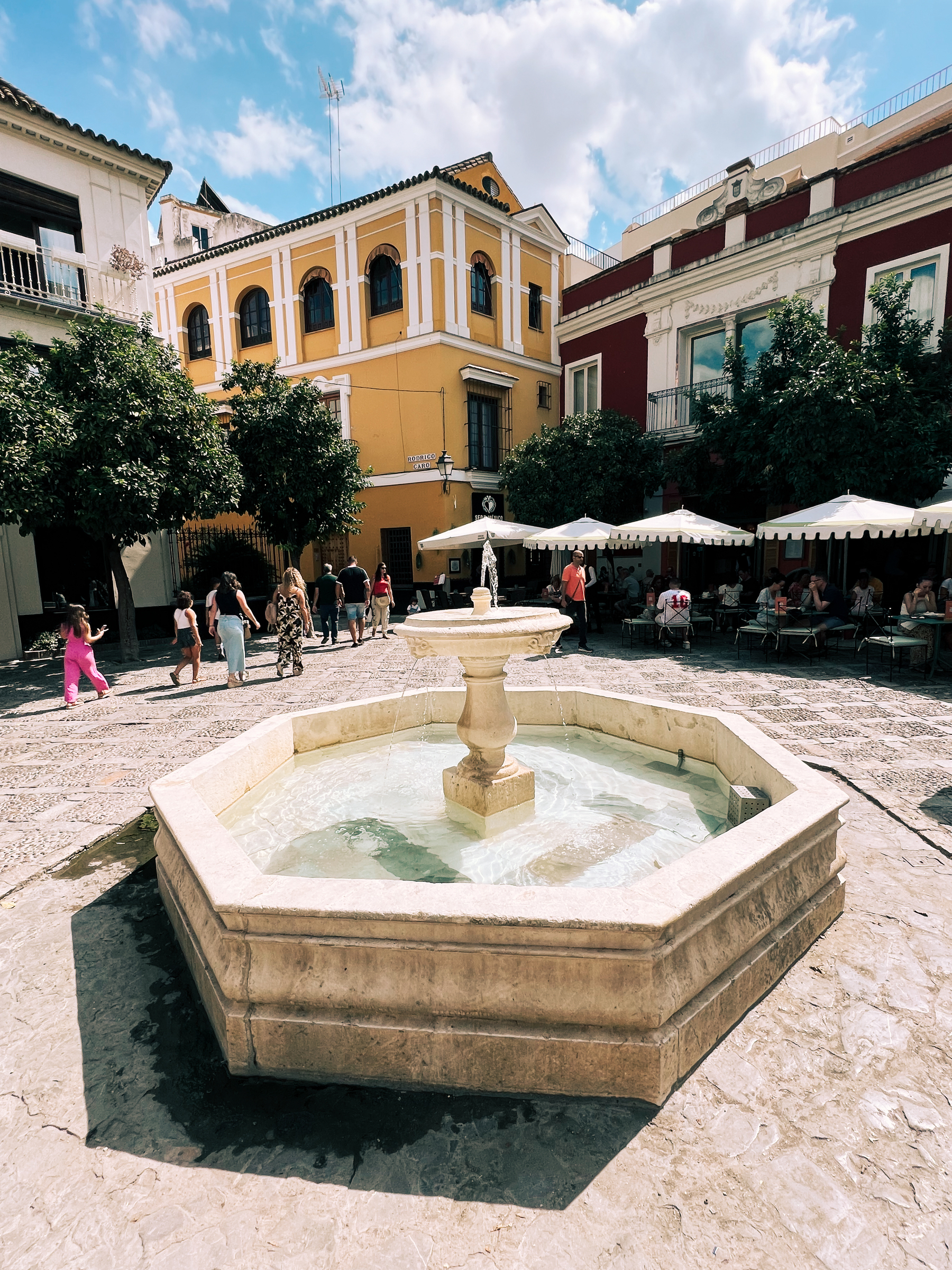 A fountain in a square in Santa Cruz, a classic neighborhood in Sevilla. Narrow streets and classic buildings. 