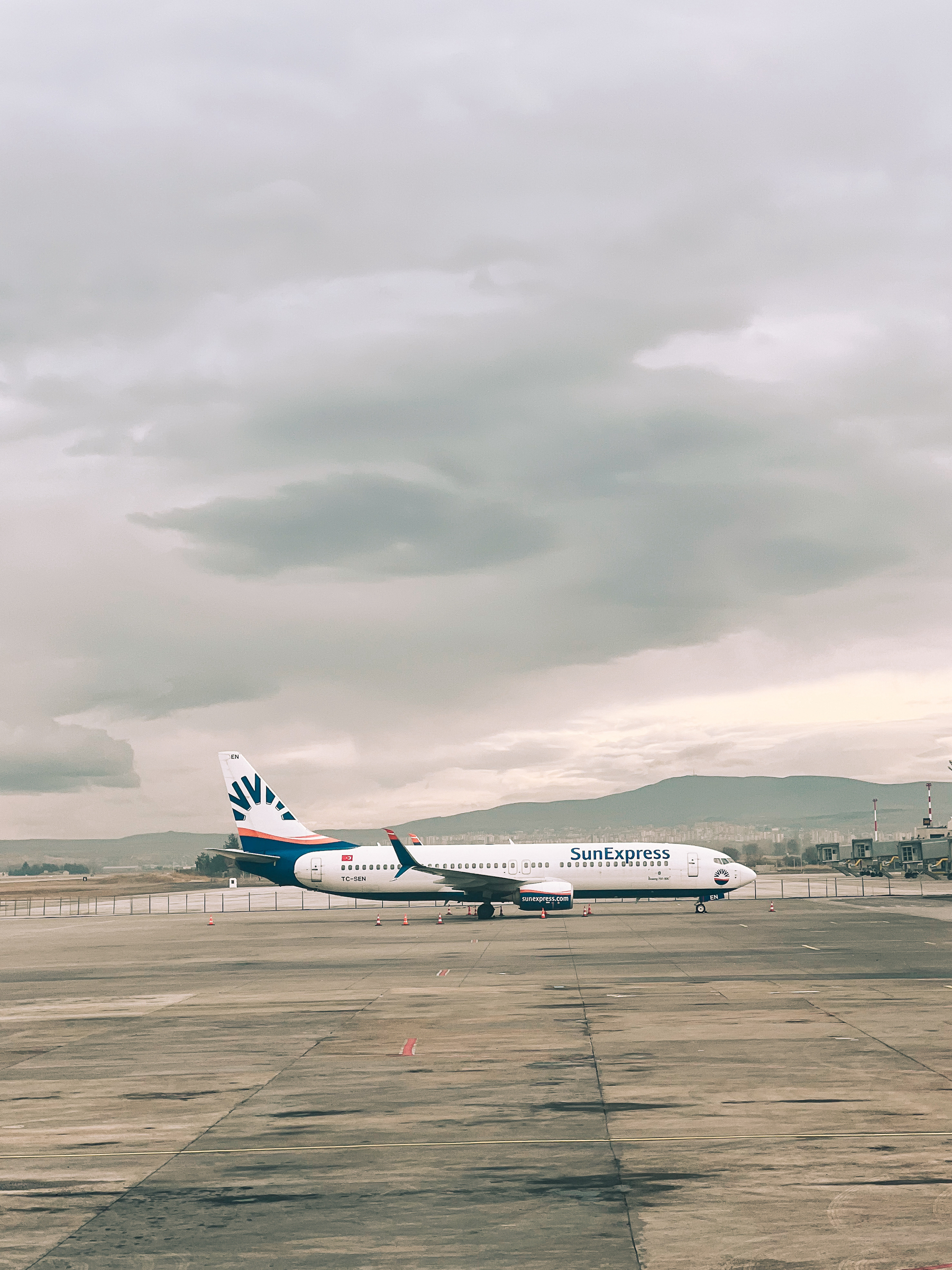 A “SunExpress” airplane sitting lonely on the tarmac. 