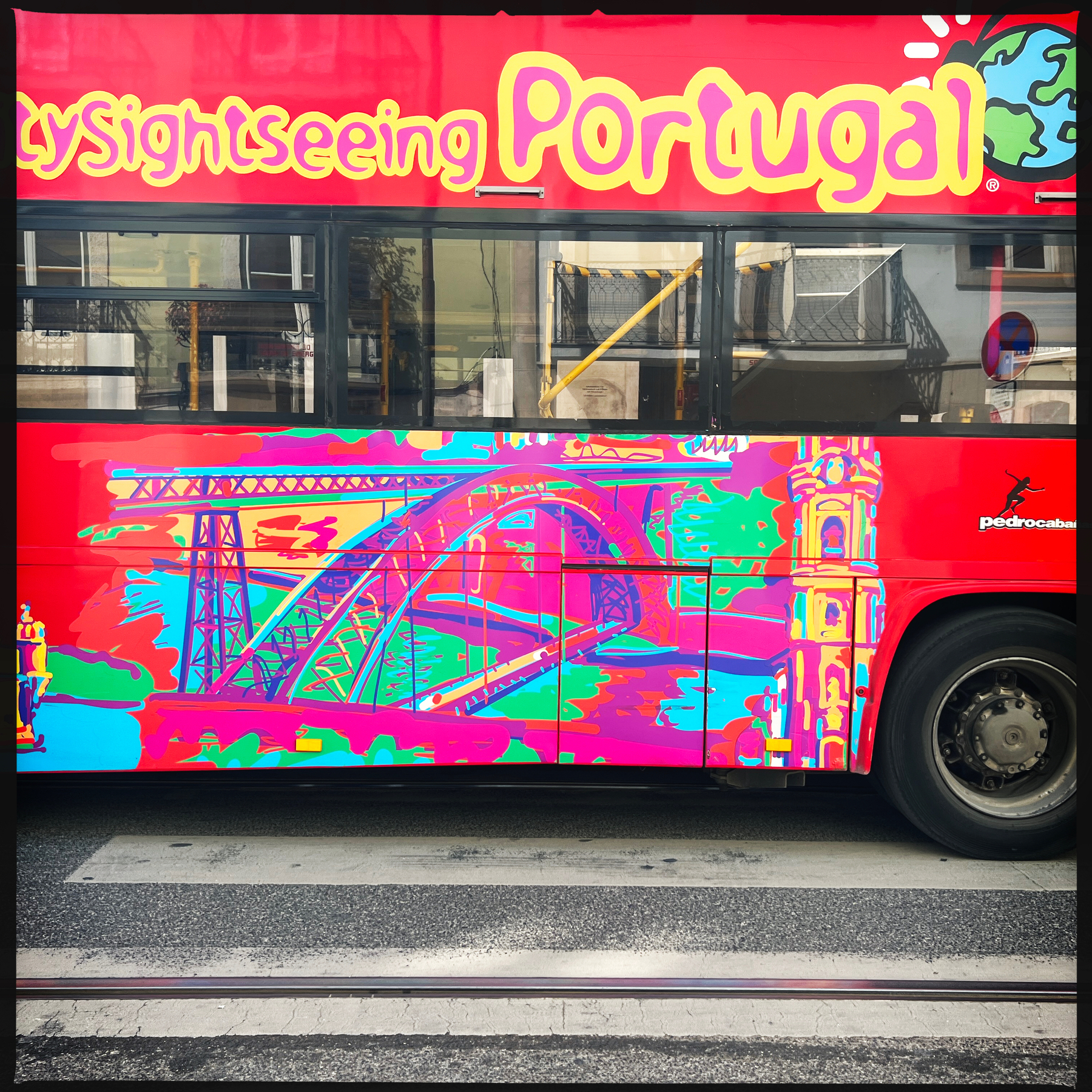 A hop on hop off bus, with “sightseeing Portugal” written on it. 