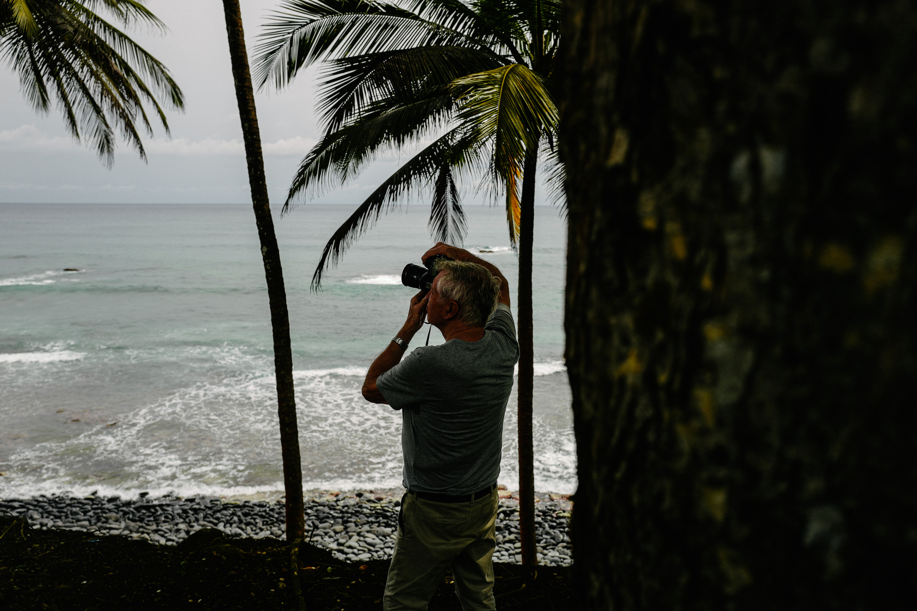 A photographer at work in a tropical beach. 