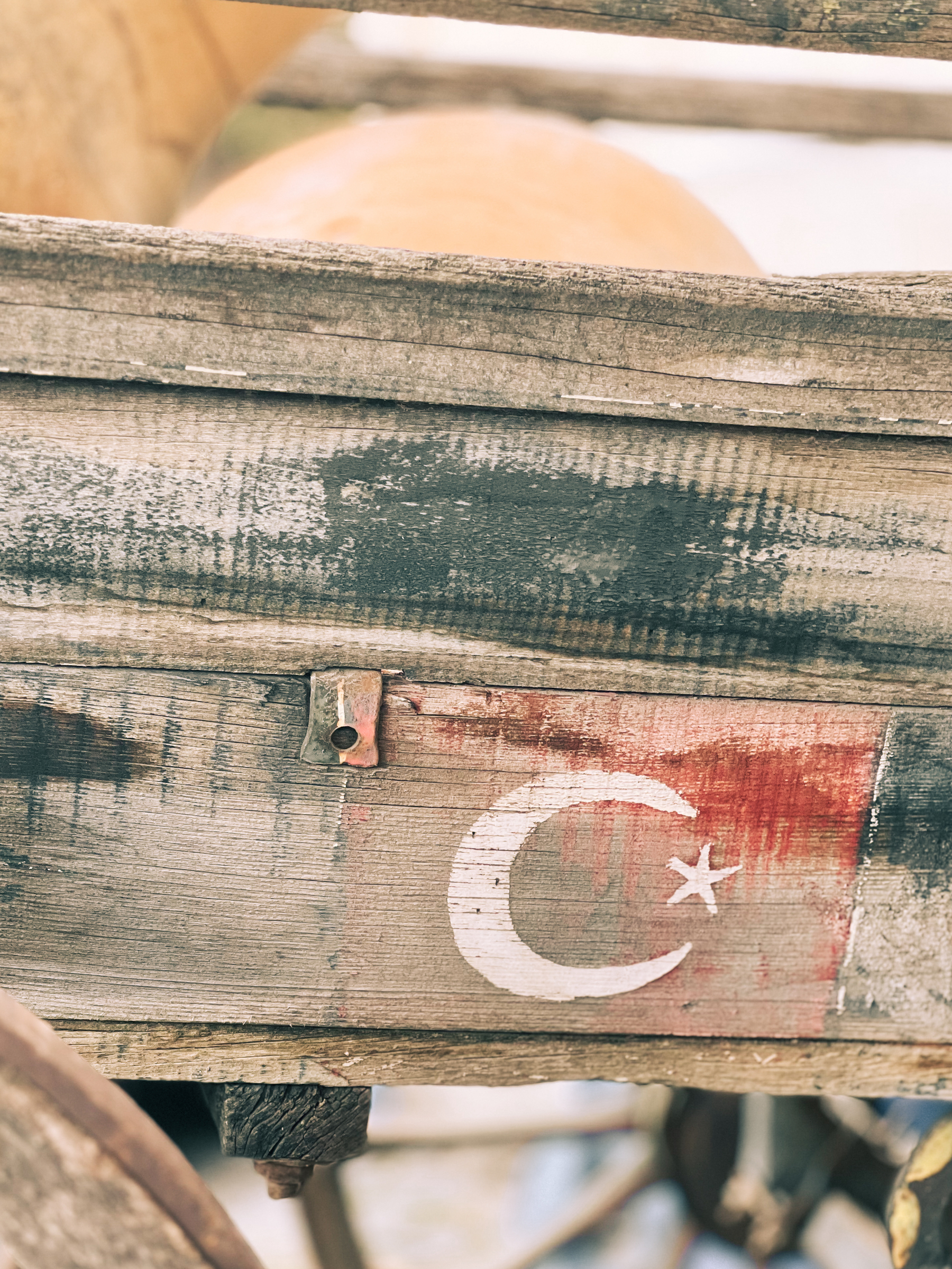 A Turkish flag painted on wood. Faded. 