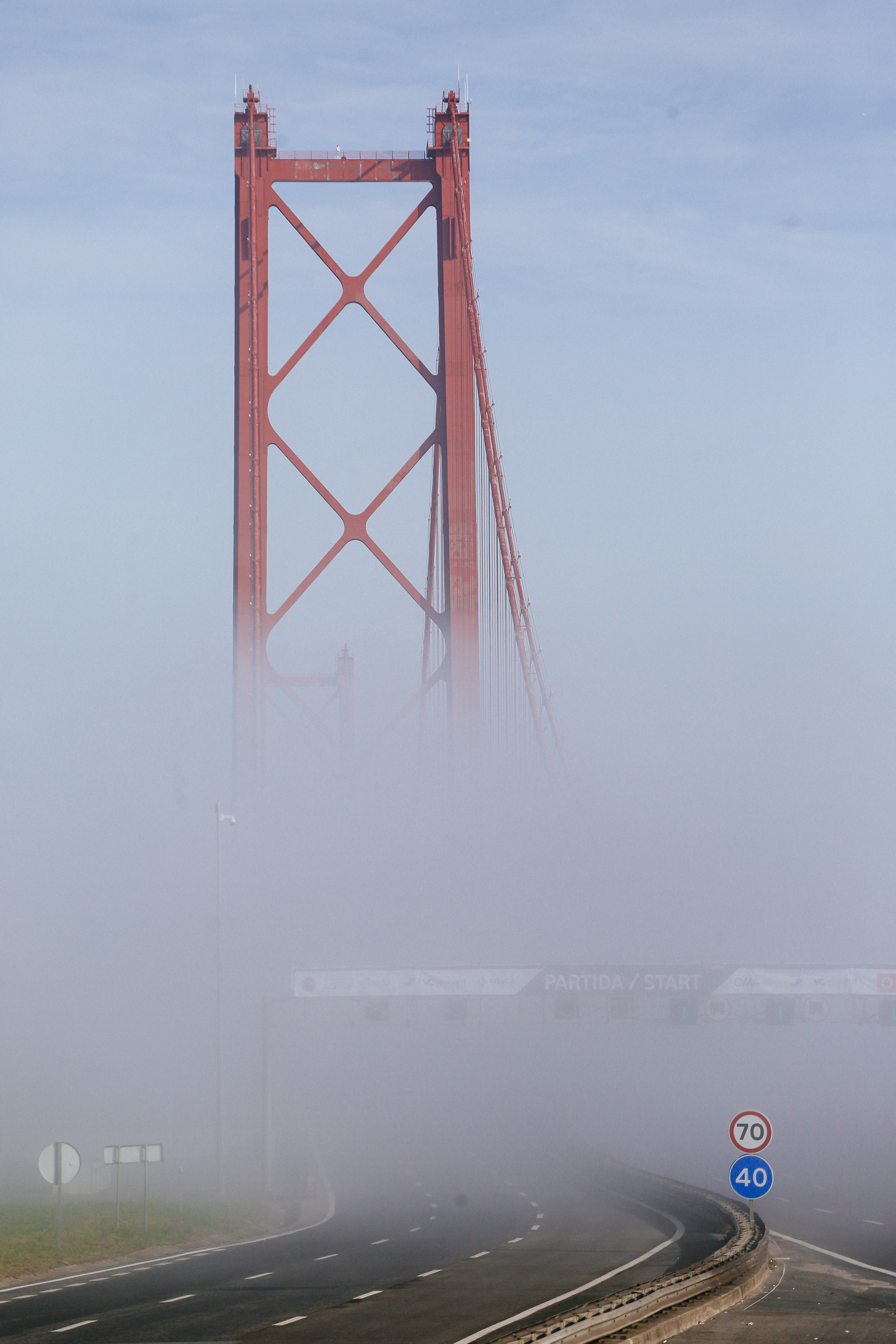 A bridge rises from the fog. 