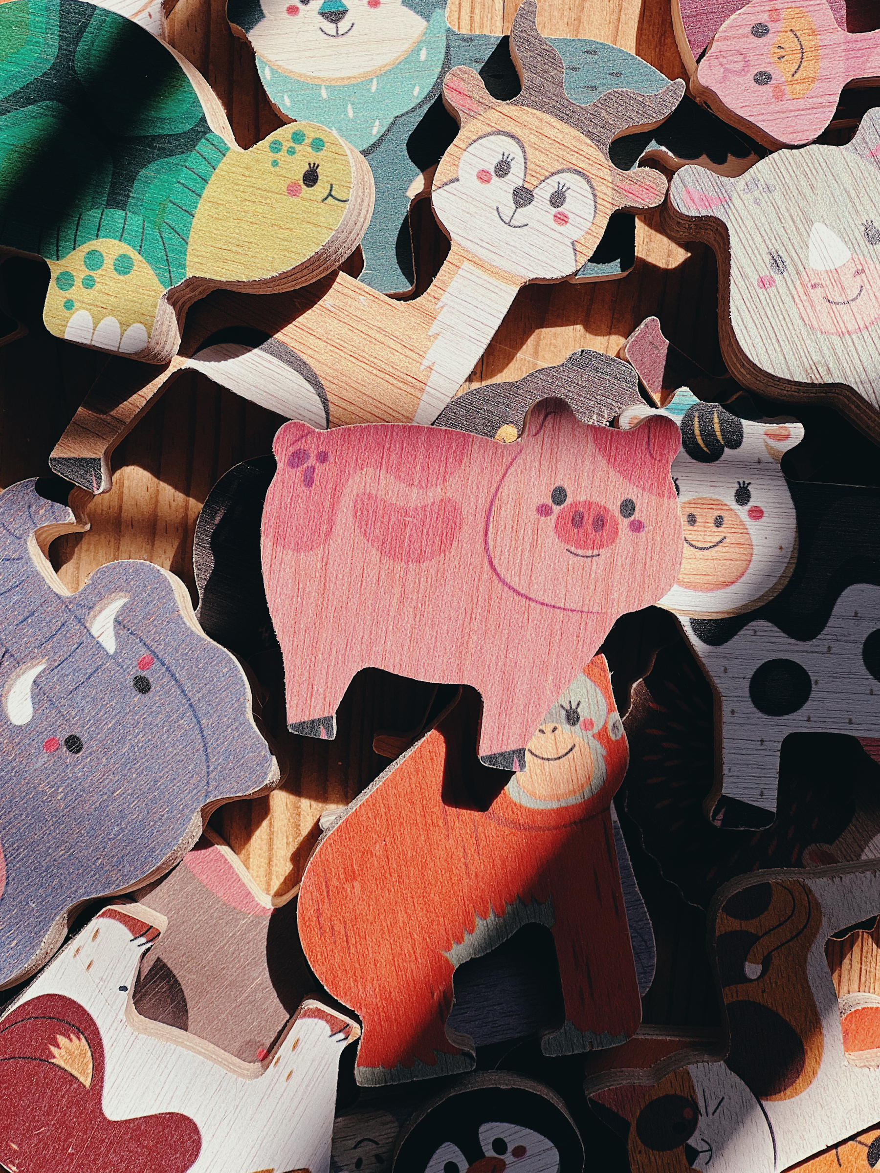 Wooden toys, animals. A pig takes center stage. 